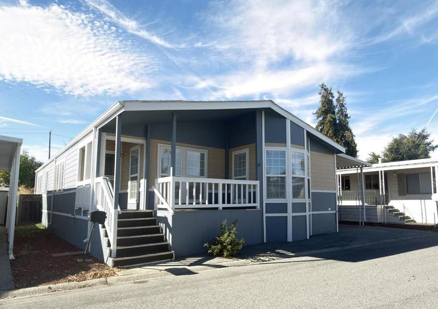 Bright and inviting 1998 Silvercrest home with 3 bedrooms and 2 bathrooms located in a highly regarded 55+ park. Recently painted exterior and interior walls. The spacious living room features new laminate flooring, a high ceiling, stack windows for abundant natural light, ceiling fan with lights, and a cozy gas fireplace. Separate dining area for everyday meals and entertaining. The beautiful kitchen boasts newer laminate flooring, a central island, and a nice layout. All bedrooms have newer carpeting, with the primary bedroom offering ample space. The first guest bedroom has double doors. The guest bathroom is updated with new laminate flooring, medicine cabinets, a bathtub and shower, and a skylight. The large primary bathroom includes a separate tub and shower, double sinks, medicine cabinets, and new laminate flooring. Double-pane windows throughout for energy efficiency, along with central A/C, a front porch entry, and a single-car carport. Additional features include a newly installed wheelchair lift for enhanced mobility, Ring doorbell and security cameras, storage shed. Conveniently close to shopping centers, grocery stores, major freeways, and Kaiser Permanente Hospital. Low space rent makes this home an excellent value.