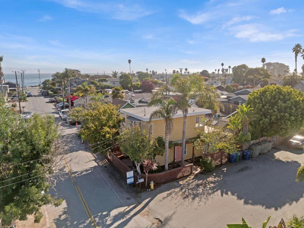 Visit this wonderful Pleasure Point beach house, one block from from East Cliff Drive and the staircases down to famous surf spots The Hook and Jacks (Jack O'Neill of surfing fame and inventor of the wetsuit lived down the street). From the second floor and roof deck you can see the Monterey Bay and watch the gorgeous fall sunsets. The home is bright and charming, with a top floor large living room that has a window seat pop-out surrounded by trees and blooming wisteria vines. The two bedrooms have ample natural light and are standard size, but to add more area, the garage has been converted into a spacious office/laundry. With low maintenance landscaping and an irrigation system, the outside is set up for a relaxing second home or an "easy life" first home. An outdoor shower is installed for the surfer, with a shed to store boards or bikes. Foremost, this is a great home in an extremely walk-able neighborhood, with quick access to ocean, renowned coffee, breakfast, and all the tiny shops of Pleasure Point and we cant wait to see you at an open house.