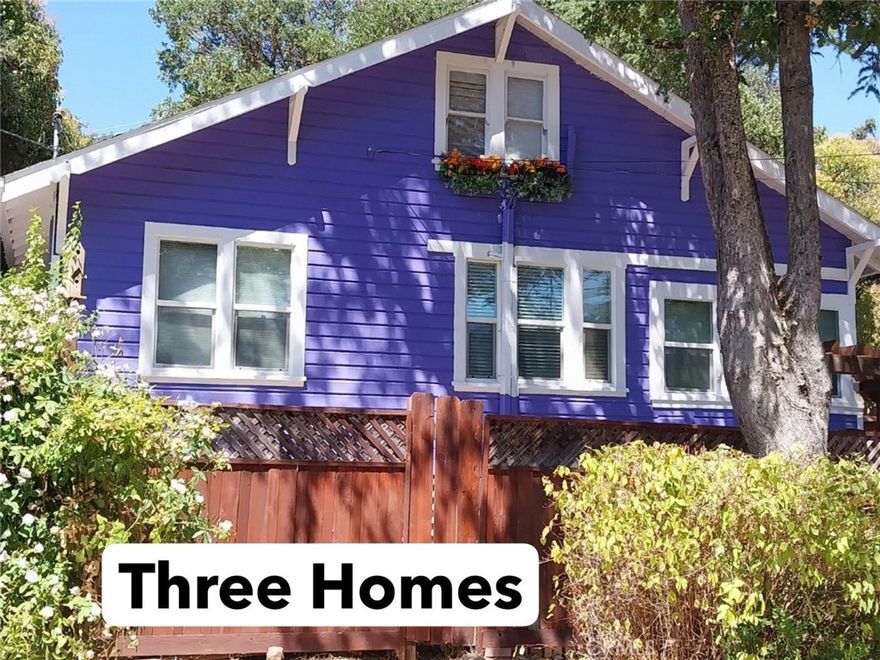 Amazing opportunity to own three homes on one large corner lot in one of Lakeport’s most desirable neighborhoods!  If you have been looking for a family compound or an investment property with great rental income and low maintenance, this one is for you! The main home is a stunning combination of historic charm with modern updates! 5bd/2.5 bath, boasts 2531sq ft and is beautifully remodeled with an open and airy floorplan. Spacious 450 sq eat-in kitchen has cherry cabinets, high end appliances, 14ft of counter space and opens to the dining hall with a wall of windows overlooking the beautifully landscaped & fully fenced backyard with garden area and small pond feature. 3 new split units plus a wood stove keep the home cozy in all seasons. Downstairs has high quality laminate flooring throughout plus the original hardwood doors, built in cabinets, beautiful lighting and coffered ceilings. Original staircase has vintage copper inserts. Enclosed summer sleeping porch has 2 twin Ikea bunk bed systems with built-in closets & desks. Main floor master bedroom connects to a master bath with claw foot tub & marble double vanity. The 2nd full bath has a custom travertine stone shower with bench. Two huge upstairs rooms with kitchenette, lots of closet space and a half bath. Lots of built in cabinets and spaces for storage throughout. Second home (Red Door House) is a 2bd/1ba Charming cottage. Totally Remodeled with laminate flooring, cherry kitchen cabinets & tiled bath with claw foot tub. Open living rm/dining area plus antique sliding barn door entrance to main bedroom. Smaller bonus room can be used as a 2nd bedroom, hobby room or walk-in closet. Wood stove & electric heat. Front yard is shaded and beautifully landscaped and has tons of curb appeal! Third home (Serenity Cottage) is an adorable 1bd/1ba set off the road. Lovely arbor leads to a gate that opens to a serene setting with natural landscaping. The back and side yards are shaded by 100+ yr old cedar trees. Custom redwood deck, new tin roof, and completely private fenced yard. Raised garden beds and a pond feature (not in use). Inside is an extra-large bedroom with closet system, living room, small kitchen & tiled bath. All homes have vinyl double glazed, low energy windows and are located within walking distance to the lake, park, downtown, shopping & transportation. Abundant parking spaces for cars, RV and more!