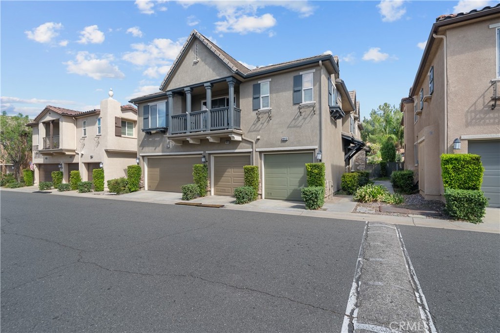 Welcome to this bright and airy townhome in the highly sought-after Mariposa community! Featuring 2 bedrooms, 2.5 bathrooms, and 1,440 sq ft of living space, this home offers comfort and style in a prime location. The open living area is filled with natural light and features a cozy fireplace and updated laminate flooring. The kitchen is beautifully upgraded with white cabinets, granite countertops, a tile backsplash, and under-cabinet lighting—perfect for both everyday living and entertaining. A designated laundry area and a dining room with a charming light fixture add to the home’s functionality and charm. Upstairs, each bedroom has its own private bathroom. The primary suite includes a spacious walk-in closet, creating a true retreat. Step outside to your private yard with mature trees, offering just the right amount of shade and privacy—rare to find in a townhome setting. Located just across from some of the hottest new restaurants in Saugus, this home combines convenience, community, and comfort.