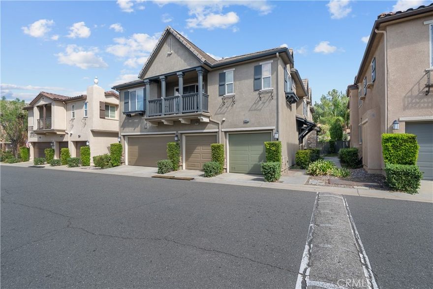 Welcome to this bright and airy townhome in the highly sought-after Mariposa community! Featuring 2 bedrooms, 2.5 bathrooms, and 1,440 sq ft of living space, this home offers comfort and style in a prime location. The open living area is filled with natural light and features a cozy fireplace and updated laminate flooring. The kitchen is beautifully upgraded with white cabinets, granite countertops, a tile backsplash, and under-cabinet lighting—perfect for both everyday living and entertaining. A designated laundry area and a dining room with a charming light fixture add to the home’s functionality and charm. Upstairs, each bedroom has its own private bathroom. The primary suite includes a spacious walk-in closet, creating a true retreat. Step outside to your private yard with mature trees, offering just the right amount of shade and privacy—rare to find in a townhome setting. Located just across from some of the hottest new restaurants in Saugus, this home combines convenience, community, and comfort.