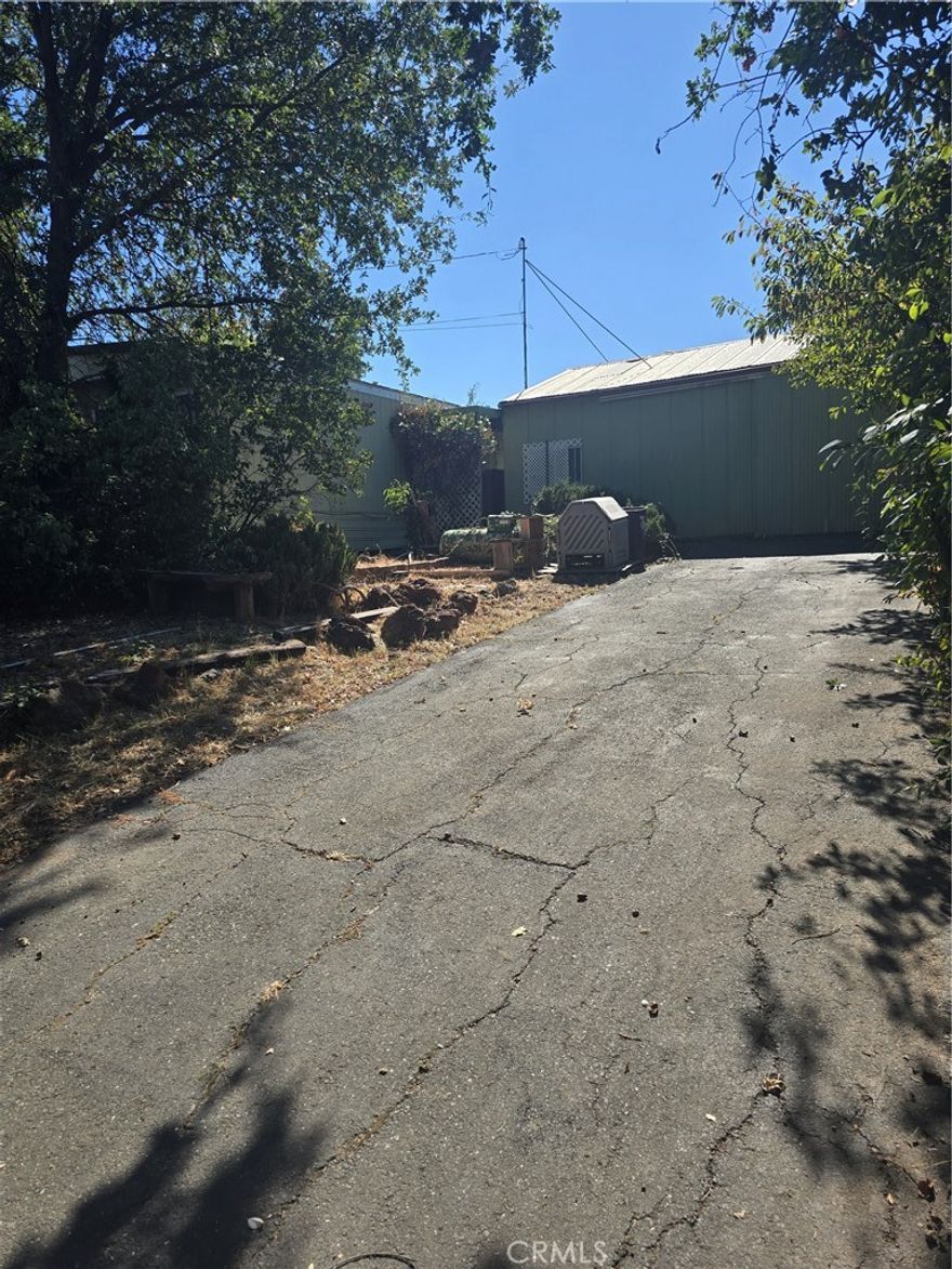 .45-acre parcel with a 2-bedroom, 2 bath manufactured home just outside Lakeport city limits. Also has a 24x28 ft metal shop perfect for all your projects, and multiple shortage units. Septic system and a well that produces 30 gpm. So, no sewer or water bills! Many fruit trees and a white grape vine 50+ years old. Also, a 20x 24 ft greenhouse and several raised garden beds for all your gardening needs. Dual driveways with a carport and room for an RV
