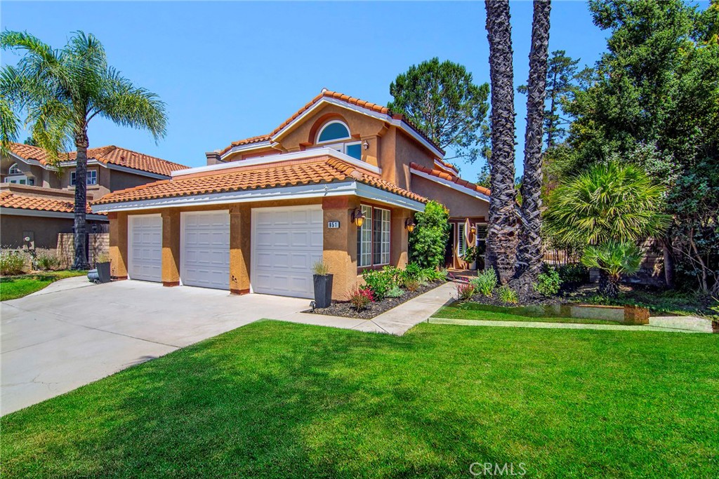 Nestled on a quiet cul-de-sac, this stunning Wood Ranch “Regalia” residence offers soaring ceilings, abundant natural light, and a spacious yet private backyard retreat. Relax by the serene Pebble Tec pool and spa while enjoying the diverse wildlife that call the hillside trees and shrubs home.
Inside, you’ll find a rare main-floor multi-purpose bonus room with vaulted ceilings, a wall of built-in cabinetry, a bar sink, and two sets of double doors opening to both the formal dining room and the pool area—perfect as a home office, artist studio, gym, guest suite, or cabana bar.
The upgraded kitchen features slab granite countertops, stainless steel appliances (including refrigerator and a back-saving double-drawer dishwasher), breakfast bar, and an oversized walk-in pantry. The downstairs bedroom—currently used as an office—offers soundproofed walls, double French doors, beautiful Acacia wood floors, and built-ins. A full shower bath is conveniently located nearby, along with a laundry room (washer and dryer included).
Upstairs, rich Acacia wood floors flow through the hallway and primary suite, with newer carpet in the secondary bedrooms. The primary suite features a walk-in closet, water closet, double-sink vanity, and new decking off its expansive balcony. A second balcony is shared by one of the secondary bedrooms. Both upstairs baths feature newer wood-look tile, and a whole-house fan with timer adds comfort and efficiency.
This home also includes solar, providing significant energy savings year-round, along with a large poolside cabana perfect for entertaining. Move-in ready with neutral paint, plantation shutters, and most windows replaced—this is a rare combination of style, comfort, and resort-style living in Wood Ranch.