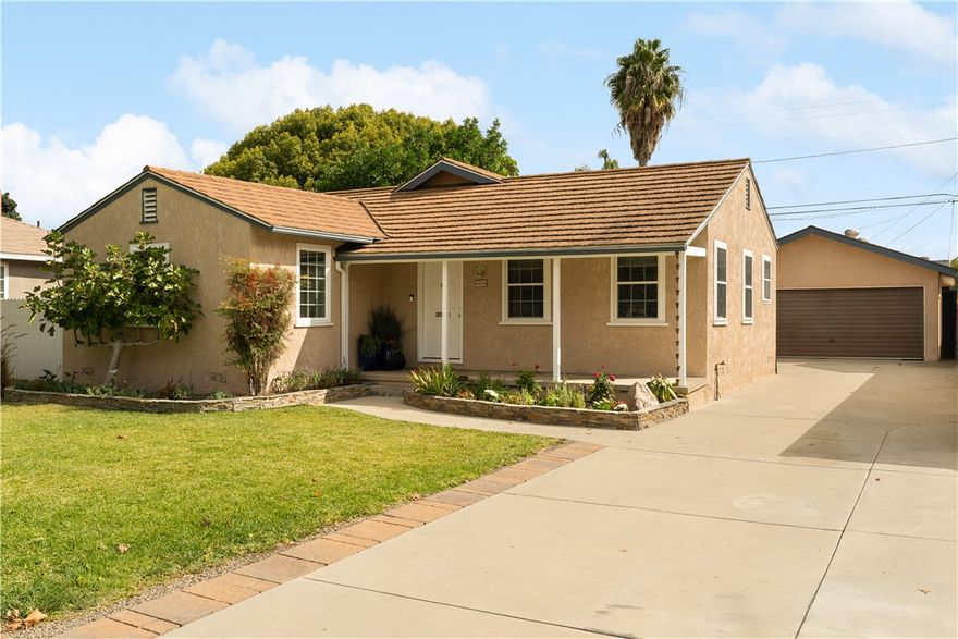 Here's a fantastic opportunity in the lovely Lakewood Village area of Long Beach that offers a picturesque single family on a generously-sized lot. Stepping through the front door, the home's first impression is an enchanting living room with wainscoting, crown moldings, and a built-in bookcase. It's a room that envelopes you in its warmth, providing a serene space to drink a morning cup of joe or curl up on a sofa to read a good book or enjoy the company of friends. Just off the living room are three charming bedrooms and a full bathroom on one side, and the kitchen on the other. The kitchen boasts stainless steel appliances, granite counters, and ample cabinetry. But that's not all. There is a spacious family room with brick fireplace that just screams for a big screen TV, comfy sectional, and offers the perfect setting for some serious binge-worthy TV. Step through the sliding glass door to a large, covered patio that overlooks the professionally landscaped backyard. And not to bury the lead, but let's talk about the endless potential of the 4-car detached garage. Imagine all the things you could do with this space: ADU, workshop, home office, game room, "mancave", "she-shed"... oh and yeah park four cars. Located on a pretty street, this home is nestled in this charming neighborhood and yet is just down the street from Home Depot and Costco. Mic drop.
