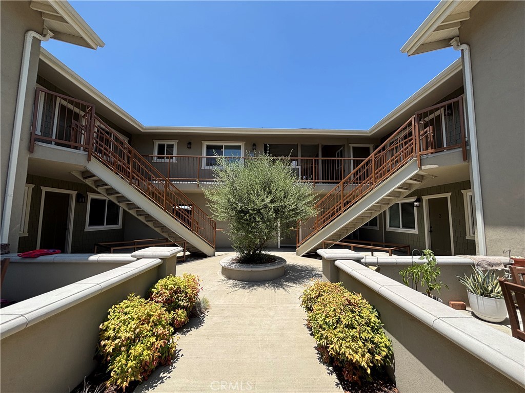 This charming ground-level unit features 1 bedroom and 1 bathroom, with stylish wood-style flooring throughout. The bright and open living and dining area connects seamlessly to a modern kitchen outfitted with stone countertops, white shaker cabinets, and stainless steel appliances—including a gas stove and built-in microwave. The bedroom includes a ceiling fan and mirrored closet doors for added comfort. With in-unit laundry hook-ups and a clean, move-in ready feel, this apartment offers convenience and comfort in a welcoming space.