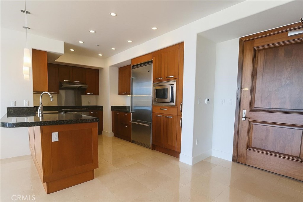 Sophisticated 11th-floor interior residence featuring 2 bedrooms, a versatile den, and 2.5 baths with sweeping panoramic views of the hills and arboretum. This upgraded home showcases designer granite finishes, Viking appliances, Lutron lighting, automated shades, and extensive built-in Italian cabinetry. The den offers the perfect space for a private home office or a guest room. No detail has been overlooked, offering both elegance and functionality. Residents enjoy world-class amenities including a stunning rooftop pool with private cabanas and an inviting fire-pit lounge—perfect for evening gatherings under the stars. Additional offerings include a spa, state-of-the-art fitness center, billiards lounge, club room, business and conference centers, concierge service, and more. Ideally located within walking distance to restaurants and just minutes from premier shopping, major freeways, and John Wayne Airport.