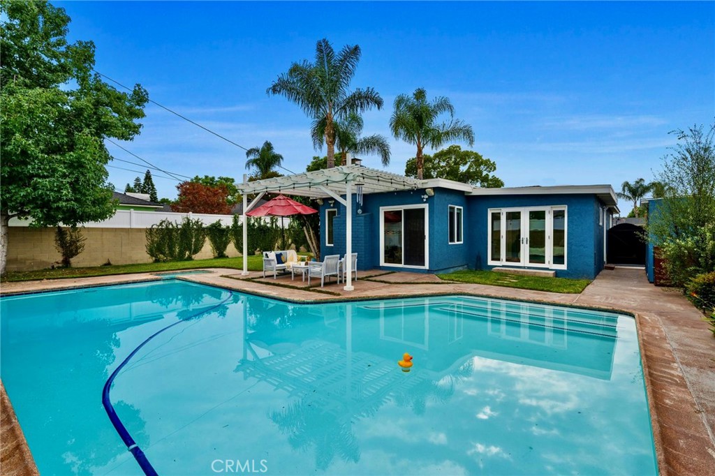 Beautifully UPDATED 3-bedroom, 2-bathroom home located in the highly sought-after “Minnie Gant” pocket of Long Beach’s desirable LOS ALTOS neighborhood. “Step inside and bathe in the LIGHT-FILLED atmosphere as you begin your next chapter. Starting with the welcoming LIVING ROOM/DINING ROOM, complete with a charming built-in Window Seat and picturesque VIEWS of the TREE-LINED Neighborhood. Next…The GOURMET KITCHEN, upgraded to include GRANITE countertops, a BREAKFAST BAR, STAINLESS STEEL APPLIANCES, a Built-In WATER FILTER, SKYLIGHT, and CUSTOM WOOD CABINETS. The spacious FAMILY ROOM showcases an OPEN-BEAM Ceiling, a cozy FIREPLACE, and a mounted 70” LED TV with an integrated SURROUND SOUND SPEAKER SYSTEM—perfect for movie nights and gatherings. Step outside to your PRIVATE BACKYARD RETREAT, complete with a HEATED POOL, relaxing JACUZZI, and an OUTDOOR SPEAKER System. Designed with both ENTERTAINMENT and RELAXATION in mind, this home offers the ultimate INDOOR-OUTDOOR lifestyle. The PRIMARY SUITE features a SPA-INSPIRED BATHROOM with an updated vanity, SOAKING TUB, separate WALK-IN SHOWER with TWO SHOWER HEADS, a BIDET, and Direct Access to the Pool. One of the Two Secondary Bedrooms has a separate Exterior, Side Entrance, and FRENCH DOORS that open to the POOL and a SKYLIGHT. The other is bright and comfortable with floor-to-ceiling shelving. The Secondary Bathroom is NEWLY REMODELED, including a Large VANITY, WALK-IN-SHOWER with RAIN SHOWER HEAD, and Built-In Bench, plus a SKYLIGHT. The converted garage provides a BONUS ROOM with a LOFT-STYLE SLEEPING area, serving as a FLEXIBLE SPACE for a Home Office, Gym, Playroom, or Guest Room. OTHER FEATURES Include: a Two-Car PARKING PAD for Off-Street Parking, TWO Large STORAGE SHEDS, DUAL PANE WINDOWS, HVAC, NEST THERMOSTAT and DOORBELL CAMERA, Schlage KEYLESS ENTRY, OUTDOOR POOL SHOWER, Outdoor UP-LIGHTING, and IRRIGATION System. This MOVE-IN-READY home has Wonderful Neighbors, and is within WALKING DISTANCE of Parks, Shops, Restaurants, and CSULB, as well as the award-winning Minnie Gant Elementary School—plus it’s only minutes from the BEACH. Seize the opportunity to make this true LOS ALTOS gem your own!
