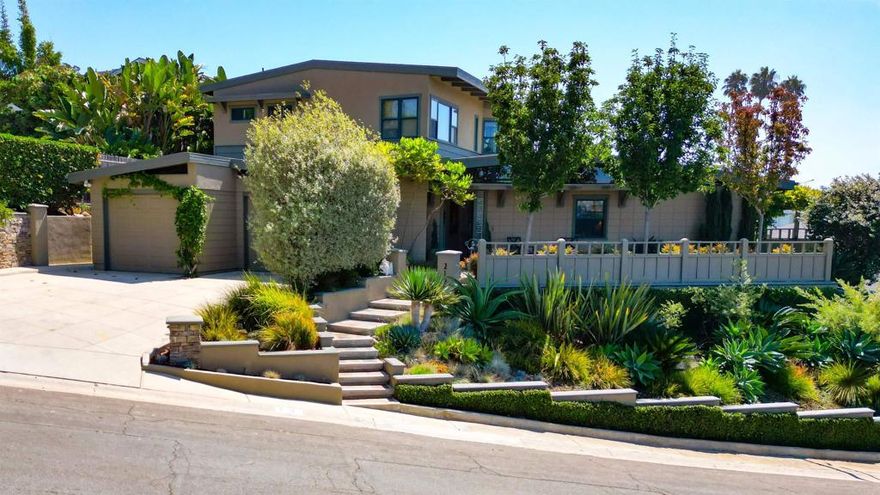Remarkable Olde Carlsbad Ocean View Home  Perched in the historic and highly sought-after community of Olde Carlsbad, this mid-century Craftsman-inspired home is as special as it is rare. Ocean views greet you from multiple vantage points, creating the perfect backdrop for an entertainer’s dream, both inside and out.   Inside, thoughtful updates blend seamlessly with timeless character: Milgard doors and windows, wide-beamed ceilings, and a double-sided fireplace anchor the main living spaces. Custom cherry wood flooring and cabinetry, plush Berber carpet, and strategic designer lighting enhance the home’s warmth and sophistication. The chef’s kitchen, complete with a generous island and direct access to the yard and built-in BBQ, is ideal for small and large gatherings.  The primary suite offers true retreat living, with sit-down ocean views, a private balcony, large walk-in closet, separate water closet, and a luxurious soaking tub. Additional highlights include a downstairs den—perfect for movie nights or a potential fourth bedroom—and a versatile loft space at the top of the stairs.  Two bedrooms and 2 1/4 bath downstairs, primary upstairs, and en suite bathroom for each bedroom!  Step outside to a backyard oasis featuring a large covered sitting and entertaining area with views to the Pacific, a tranquil water feature, custom fencing, along with ample yard and lawn for kids and pets. Whether hosting friends or enjoying quiet evenings, this outdoor haven is made for relaxation and fun. NO HOA