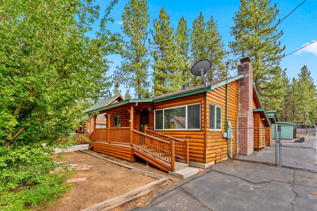 Welcome to your spacious mountain retreat! This warm and inviting 2-bedroom, 2-bath log-style home offers 1,352 sq ft of living space on a generous 5,000 sq ft lot--just moments from the ski slopes, Meadow Park on Big Bear Lake, and the Village's vibrant shops and dining. Step inside to discover a massive living room with vaulted ceilings and a cozy mountain vibe, fantastic for entertaining or relaxing by the fire. Open floor plan with a spacious kitchen. The wet bar adds a touch of fun, while the dedicated laundry room enhances everyday convenience. Out back, a substantial storage shed/workshop provides endless possibilities for hobbies or gear. Zoned C2 with a legal nonconforming residential use, this property offers unique flexibility in a central location that's hard to beat. Whether you're seeking a full-time residence, weekend getaway, or creative investment, this home is ready for your personal touch. Come make it your own and enjoy the best of Big Bear living!