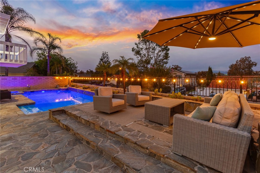 Welcome to this beautifully upgraded Casa Sarga floor plan, nestled in the heart of Mission Viejo’s desirable Madrid neighborhood. This expansive 5-bedroom, 3-bathroom home offers just under 3100 square feet of living space on a generous 10,400 square foot lot. A gated, stone-paved courtyard enhances the arrival prior to entering the home. Step into a grand, light-filled foyer with soaring ceilings and an elegant staircase, offering an immediate sense of space and sophistication. Inside, you'll find a thoughtfully designed interior with a high end laminate wood flooring, a stacked-stone fireplace, and a spacious formal living area perfect for entertaining. The gourmet kitchen features quartz countertops, beautiful white cabinets, stainless steel appliances, and kitchen island. A main-level bedroom and full bath offer flexibility for guests or multi-generational living. Upstairs, the luxurious primary suite is a true retreat with a jacuzzi tub and panoramic views of the impressive Saddleback Mountain, Lake Mission Viejo, and the Oso Creek Golf Course. The beautifully landscaped backyard is your private oasis, complete with a pool, spa, and built-in BBQ. The side yard is a great extension of the backyard allowing for various activities when entertaining or a secondary patio for the downstairs bedroom. Additional upgrades include newer vinyl windows, modernized bathrooms, and a three-car garage with approx 110sqft of attic storage space with a pull down staircase and AC. The large lot offers the potential for RV parking or a basketball / sports court. Situated on a single-loaded street with access to top-rated schools and Lake Mission Viejo amenities, this exceptional home offers both privacy and convenience. Whether you’re relaxing poolside or enjoying the expansive indoor layout, this is the perfect blend of comfort, style, and California living.