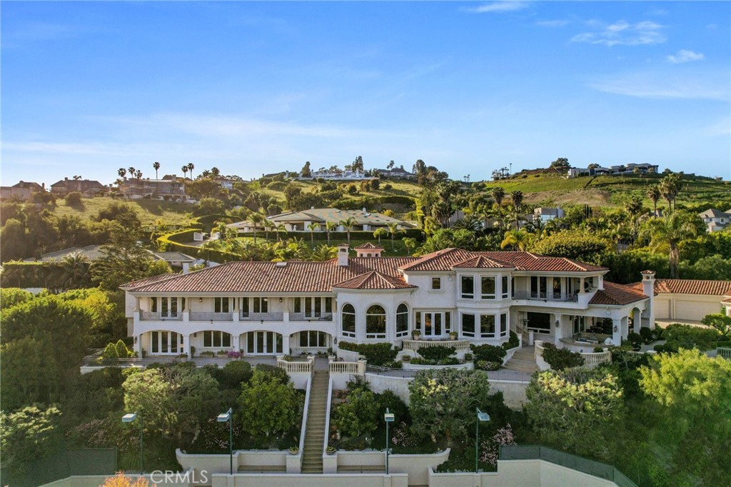 Nestled within the exclusive gated community of Bear Brand Ranch in Laguna Niguel, this magnificent estate illustrates luxury living. This stunning property was rebuilt, boasting 10 bedrooms, 11.5 bathrooms, and an estimated 13,500 square feet of living space on a sprawling 1.41-acre lot, Offering the ultimate in privacy and elegance. Upon entry, you are greeted by a grand foyer with soaring ceilings and exquisite custom woodwork throughout, setting the stage for the unparalleled craftsmanship found throughout the home. The spacious living areas are bathed in natural light and feature custom-designed furniture, creating an ambiance of sophistication and comfort. The gourmet kitchen is a chef's delight, featuring top-of-the-line appliances, custom cabinetry, and a large island, all accented by custom woodwork. The adjacent dining room offers a perfect setting for formal meals, while the cozy family room with a fireplace provides a warm and inviting space to relax. The luxurious primary suite is a private sanctuary, complete with a spa-like bathroom, a sitting area, and a private balcony overlooking the meticulously landscaped grounds. Each additional bedroom is generously sized and features its own en-suite bathroom, providing comfort and privacy for family and guests alike. Outside, the resort-style grounds are an entertainer's dream, featuring a tennis court, a fully renovated pool and spa, and multiple outdoor seating areas. The expansive lawn is perfect for hosting events or simply enjoying the serene surroundings in total privacy. Additional features of this exceptional estate include a six-car garage, a wine cellar, a home theater, and a gym. Located just minutes from world-class beaches, shopping, dining, and entertainment, this is a rare opportunity to own a truly exceptional property in one of Orange County's most coveted communities. Experience the embodiment of luxury living in Bear Brand Ranch. Schedule a private tour today and discover the extraordinary lifestyle that awaits you!