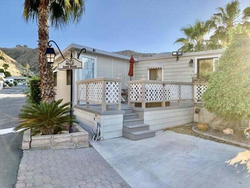 Enjoy this charming Tiny Vacation Home with open concept main living area. Min 3 months rental. Located in wonderful desert retreat in Sungate, a gated, 55+ Senior Community tucked away in a gorgeous cove at the base of a mountain range. Enter the home via a sliding door off the large patio leading to your living room with a TV cabinet with an electric fireplace, a ceiling fan and window screens for privacy. The home also offers, wood looking laminate flooring, a granite counter kitchen, glass tile backsplash, white appliances, a pantry closet and wood cabinets, including upper cabinets with glass doors to highlight your special collection of glassware. The updated bathroom is updated with stand-a-lone shower and updated quartz counter. The primary bedroom has custom storage closet space, a private sink, stackable washer and dryer and a door leading to outside patio. Due to the unique extended space of the home, there an adjacent 2nd bedroom which could be used as a den/office. It has a with built-in dresser, closet space, wall cabinets and ceiling fan. Community contains 2 swimming pools, hot tubs, fitness room, library and community center offering monthly events. Indian Land lease is $96 a month and LOW HOA fee of only $228 a month. It offers close proximity to Palm Springs International airport, shopping, grocery and other desert community amenities, including Rancho Mirage Ritz Carlton and Frank Sinatra Drive. Special home in a unique community.