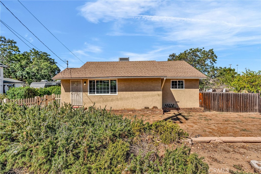 Large yard with plenty of room for a motor home or toys. Large oversized garage. Newer central air conditioning and heater; Vinyl dual paned windows; water heater. Whole house fan to help cool off the home quickly.