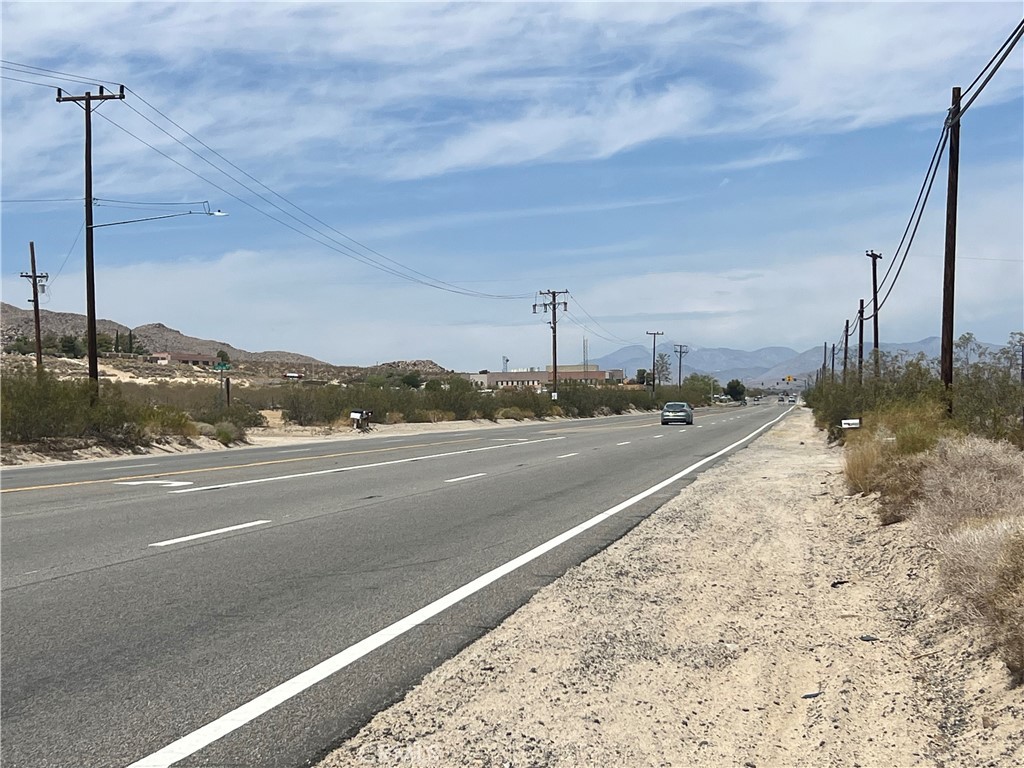 LOCATION, LOCATION, LOCATION. This lot of land is located directly on 29 Palms Hwy, just 2 miles from the Joshua Tree Courthouse and Hi-Desert Medical Center. It is also situated close to the main entrance of the Joshua Tree National Monument!!!. The seller will also carry paper. There is access to water, but no meter.