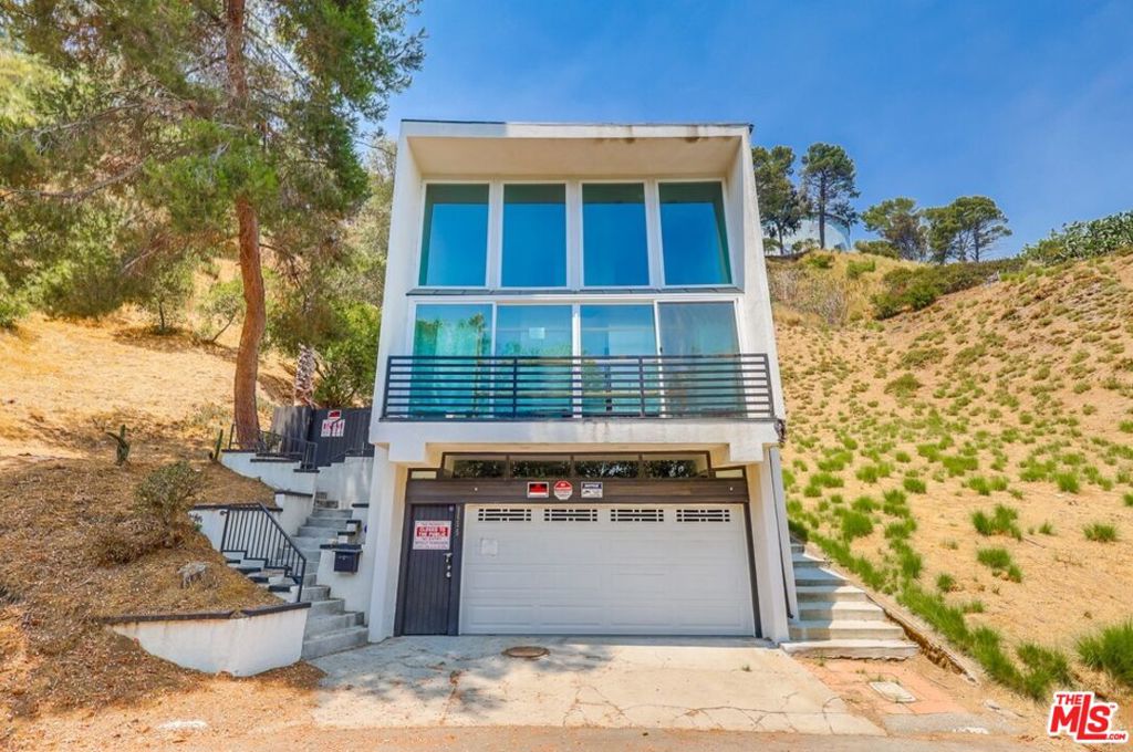 Architecturally designed home nestled in the desirable West Sunset Laurel Canyon community, just moments from Hollywood Blvd, Sunset Blvd, and Melrose. This unique fixer presents a rare opportunity to reimagine a one-of-a-kind residence featuring stunning views from a front-facing balcony that spans the living room. The interior awaits a full remodel, but already showcases striking elements such as high ceilings, multiple fireplaces, and a dramatic open layout. Upstairs, a loft connects to a Jack-and-Jill bathroom shared with a third bedroom, while the spacious primary suite offers a master bath and serene outlooks. The private backyard features a large, waterproof deck and courtyard-style seating area surrounded by lush greenery and mountain viewsideal for tranquil outdoor living. Located near the highly acclaimed Wonderland Avenue Elementary School, this home offers endless potential in a prime canyon setting.