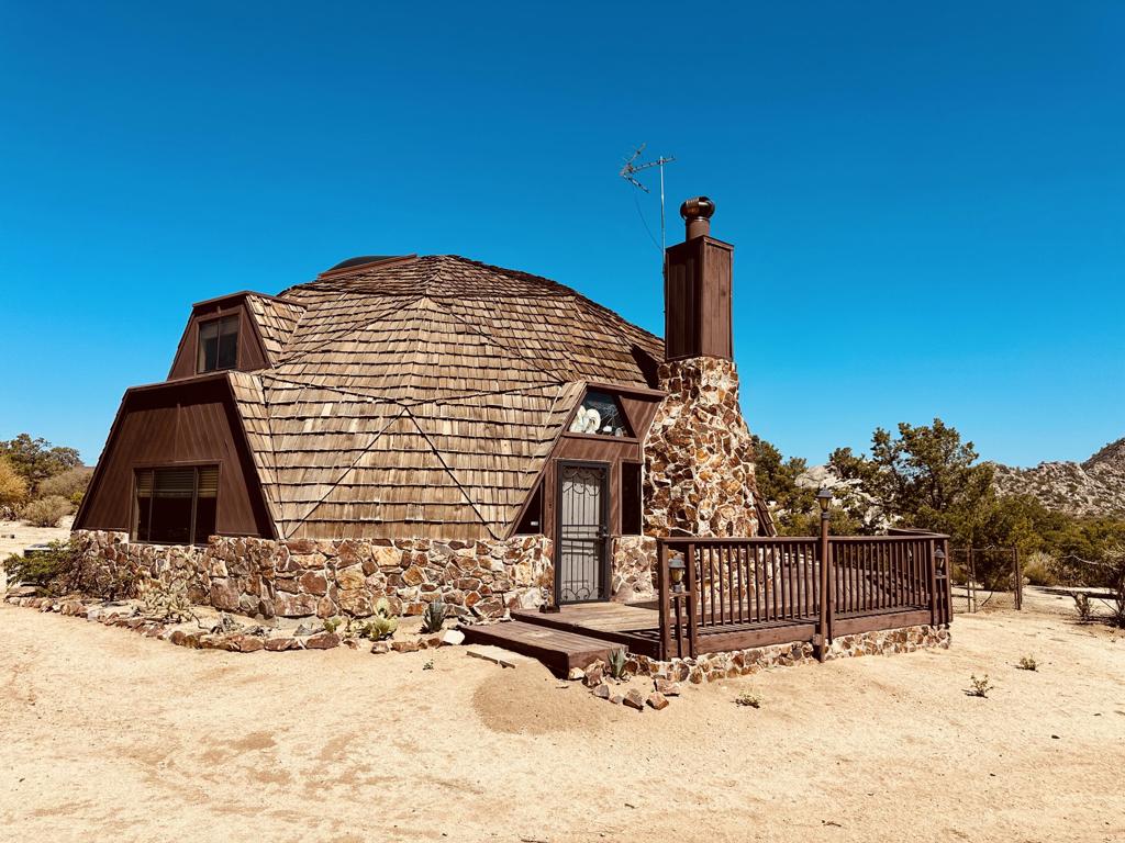 Own an iconic geodesic dome home in Pinyon Crest, just 20 minutes from El Paseo in Palm Desert. Set on 1.03 acres with stunning mountain views, this classic R. Buckminster Fuller design features a natural rock fireplace, custom stained glass, and abundant natural light. Enjoy a fenced yard, deck, spa, and ample space for outdoor living and development potential. The HOA maintains community-owned wells, providing fresh, clean water to all residents, graded roads, mailboxes and locking back gates for security and privacy. Pinyon Crest is a national monument and wildlife habitat, 10-20 cooler than the desert cities below. Home is being sold ''as-is, where-is'' and priced to sell--an outstanding opportunity to purchase in this unique mountain community.
