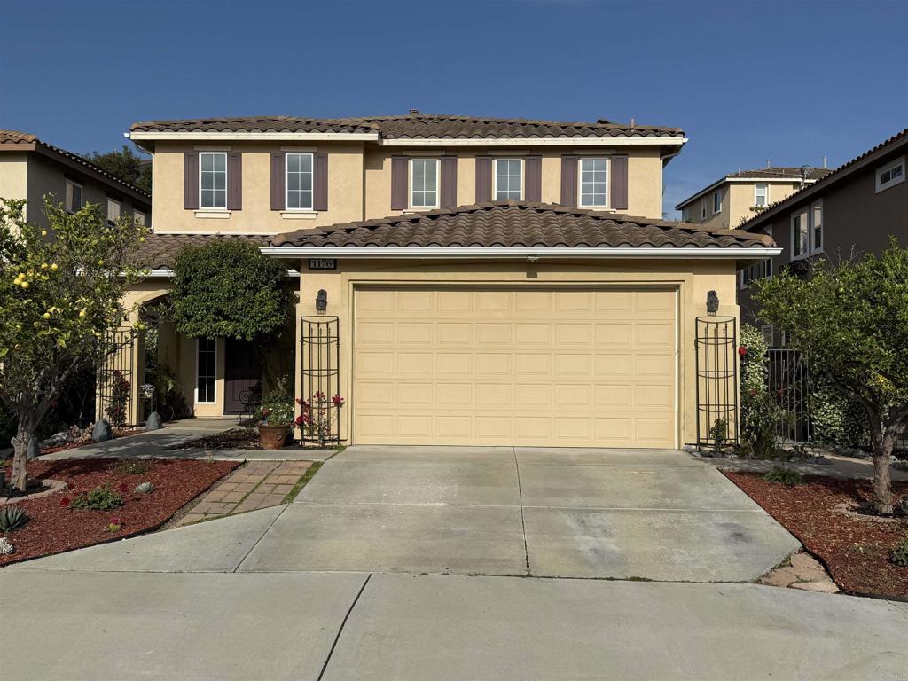 Indulge in luxury living in this stunning Augusta Arrowood residence — tucked away on a quiet streets, surrounded by lushly landscaped grounds and steps from the community’s Junior Olympic pool, clubhouse, and walking trails and the house is less than a mile from the San Luis Rey Gate of Camp Pendleton. The open and flowing floor-plan showcases engineered wood floors throughout the downstairs, creating a warm and inviting ambiance that complements the home’s abundant natural light. Inside, you’ll admire the open concept kitchen with a center island, pot rack, granite countertops, stainless steel appliances, and ample cabinetry, seamlessly connecting to the dining area and the living room with a cozy fireplace and surround sound all surrounded by a wall of windows and sliding door with views to the backyard. Retreat upstairs to the striking primary suite with plantation shutters, a spacious walk-in closet with built-in organizers, and an ensuite bath featuring dual sinks, a soaking tub, a separate shower, and a vanity area. Two additional bedrooms, a well-appointed hall bath, and a custom built-in hall cabinet complement the upper floor. Practical amenities include a laundry room with plenty of storage cabinets, new carpet upstairs, an electric car charger, attic storage, leased solar panels, and ample storage throughout. Escape to the meticulously landscaped backyard boasting stamped concrete, terraced garden boxes, a spa under a gazebo, a side yard with raised garden boxes, four citrus trees, a drip system, and a dedicated dog run—perfect for entertaining or relaxing outdoors. Enjoy the unparalleled lifestyle offered by Arrowood’s master-planned community, which includes a clubhouse with BBQ area, an 18-hole championship golf course, walking trails, playgrounds, and proximity to Luiseno Park with lighted tennis courts, sports fields, and playgrounds. The sellers are open to negotiating terms for assumption of their VA loan at a competitive 4.49% interest rate with an approximate balance of $777,000, offering buyers an exceptional financing opportunity. All this, plus being located within the coveted Bonsall Unified School District, makes this home an extraordinary opportunity to live in luxury at its finest.