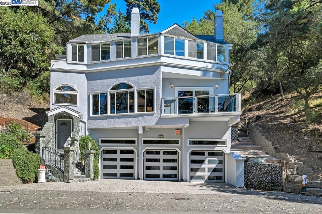 Discover 7716 Skyline Blvd, a custom-built Montclair residence that seamlessly blends timeless design with modern luxury. This 3-level home offers 4 bedrooms, 4 bathrooms, and 4,019 sq ft of living space on an 8,413 sq ft lot. The entry level features a spacious 3-car garage and ample driveway parking. Upstairs, the main floor is the heart of the home, where a dramatic marble fireplace anchors the living room, and the open kitchen and family room are surrounded by skylights and expansive windows that fill the space with natural light. On the top floor, you’ll find all bedrooms plus a dedicated home office, including a beautifully renovated primary suite with a spa-inspired bath featuring a steam shower and dual jacuzzis. Multiple patios connect indoor and outdoor living, perfect for entertaining or simply enjoying the serene hillside setting. Practical updates add peace of mind with a new water heater in 2025, a six-year-old roof, and fresh exterior paint, stucco, and trim completed in 2021. Set in the coveted Montclair neighborhood, this home offers wooded privacy while being just minutes from shops, dining, and Oakland’s vibrant amenities. A rare hillside sanctuary with the perfect balance of tranquility and convenience.