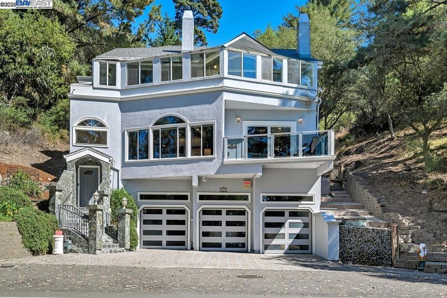 Discover 7716 Skyline Blvd, a custom-built Montclair residence that seamlessly blends timeless design with modern luxury. This 3-level home offers 4 bedrooms, 4 bathrooms, and 4,019 sq ft of living space on an 8,413 sq ft lot. The entry level features a spacious 3-car garage and ample driveway parking. Upstairs, the main floor is the heart of the home, where a dramatic marble fireplace anchors the living room, and the open kitchen and family room are surrounded by skylights and expansive windows that fill the space with natural light. On the top floor, you’ll find all bedrooms plus a dedicated home office, including a beautifully renovated primary suite with a spa-inspired bath featuring a steam shower and dual jacuzzis. Multiple patios connect indoor and outdoor living, perfect for entertaining or simply enjoying the serene hillside setting. Practical updates add peace of mind with a new water heater in 2025, a six-year-old roof, and fresh exterior paint, stucco, and trim completed in 2021. Set in the coveted Montclair neighborhood, this home offers wooded privacy while being just minutes from shops, dining, and Oakland’s vibrant amenities. A rare hillside sanctuary with the perfect balance of tranquility and convenience.