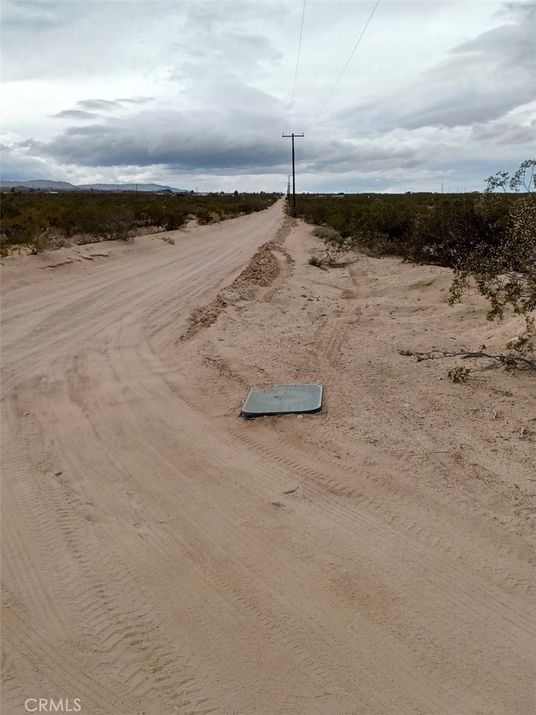 Discover 5 acres in Landers near the iconic Giant Rock. This parcel offers both beautiful views and convenience, with a power pole and what appears to be a water box cover at the corner of Bodick Rd. and Broadway (buyer to verify utilities with county). Surrounded by natural wonders, you’ll find Spy Mountain and Goat Mountain nearby for hiking and exploration, while Joshua Tree National Park is just about 30 minutes away. Whether you’re looking to invest, build, or simply enjoy the peaceful desert setting, this property is full of potential. Don’t wait—opportunities like this in Landers go fast. Come see the possibilities today! APN: 0635-141-45-0000. Latitude:34.339131, Longitude:-116.429012.