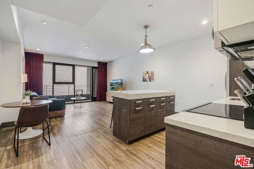 Experience elevated downtown living at The Piano Lofts, located at 932 South Hill Street in the heart of DTLA's vibrant South Park district. This fully furnished 2-bed/1-bath residence blends industrial design with modern comfort, featuring soaring ceilings, polished concrete or hardwood floors, and expansive windows that fill the home with natural light. The spacious open layout creates a seamless flow between living, dining, and kitchen areas, ideal for both relaxing and entertaining. The contemporary kitchen is equipped with stainless steel appliances, sleek cabinetry, a microwave, a dishwasher, and a full-size refrigerator. A private balcony offers the perfect spot to enjoy city views and fresh air. Convenience abounds with an in-unit washer and dryer, stylish furnishings, and thoughtful design details throughout. The bedroom provides generous closet space and abundant natural light, while the modern bathroom includes upgraded finishes and designer fixtures. Every element has been curated for a comfortable, turn-key lifestyle. Located moments from LA Live, Crypto.com Arena, Whole Foods, and some of the city's best dining, shopping, and entertainment, The Piano Lofts offer the ultimate downtown experience. This is more than a homeit's a lifestyle defined by creativity, energy, and modern luxury.