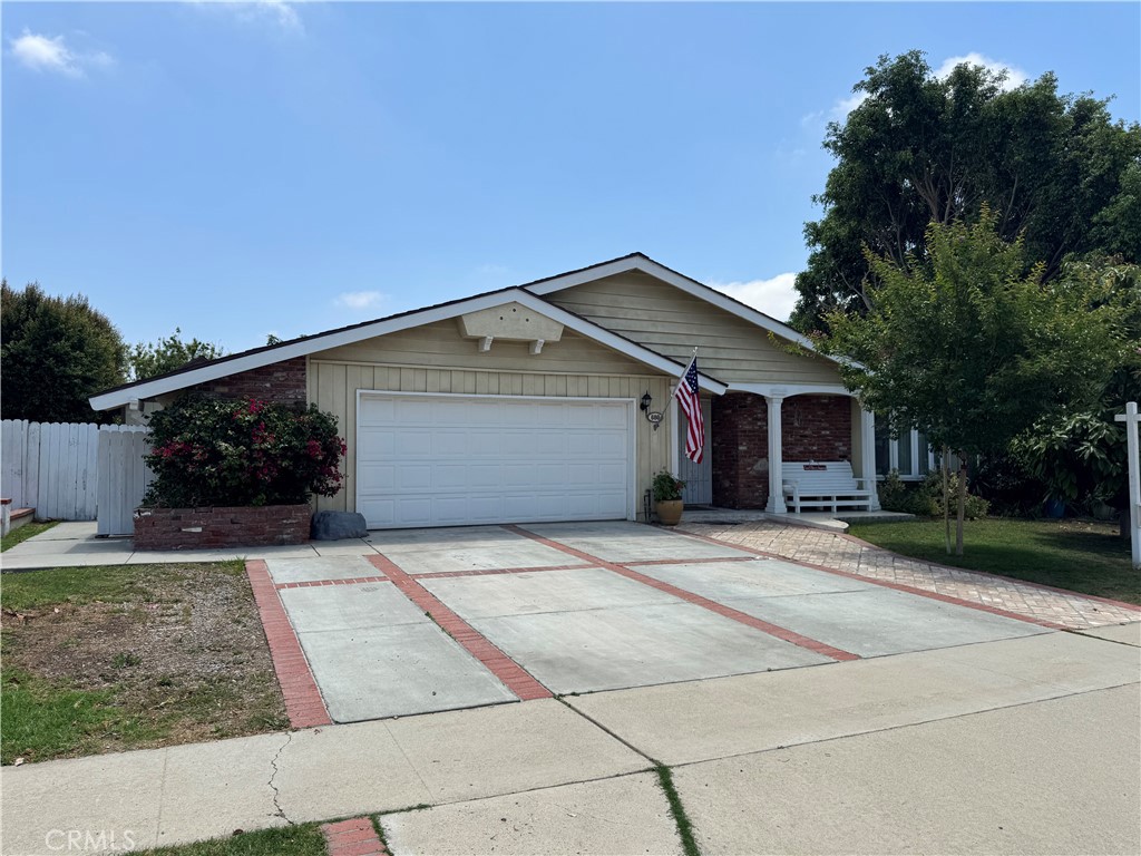 This spacious 4-bedroom, 2.5-bath, single-level detached home with a two-car garage is ideally located in Brea, just minutes from Whole Foods, shopping, dining, and the Valencia & Imperial Hwy hub. The large family room features a cozy fireplace and flows into the dining area. The beautifully remodeled kitchen features granite countertops, a breakfast bar, and a stainless-steel sink overlooking the private side patio. The en-suite master bedroom offers dual sinks, tile and wood flooring, mirrored wardrobe doors, and access to both the lush backyard and side patio. The hallway bathroom has been tastefully updated. The 4th bedroom, currently separated from the entertainment room, opens to the side yard. Custom tile work adds charm to the entry and hallways. Enjoy a spacious backyard with mature landscaping, fruit trees, and a large, covered patio. An additional detached mobile room serves as a flexible office or guest space (not included in square footage).
