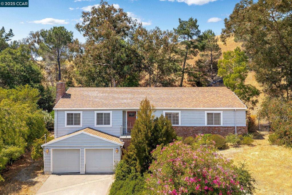 Spacious and flexible, this single-story home with bonus space below is tucked at the end of a quiet cul-de-sac. Located in one of Moraga’s best neighborhoods, this property offers an ideal opportunity for those seeking versatility, value, and access to top-rated schools. Set on nearly half an acre, the main level features three bedrooms, two bathrooms, a generous living room with a fireplace, and a kitchen that overlooks the private hillside. Hardwood floors run throughout. Downstairs, a separate bonus room with direct access to the backyard and deck provides flexible space for a family room, home office, gym, or game room—perfect for changing needs. The expansive deck is surrounded by mature trees, creating a serene outdoor setting with ample space to entertain, garden, or explore future expansion. Just one mile from Campolindo High and served by Moraga’s award-winning public schools. Enjoy quick access to Rheem Valley Shopping Center, Moraga Commons Park, and the Lafayette-Moraga Trail. Nearby Saint Mary’s College brings performances, lectures, and Division I athletics to the community. With Orinda BART and Highway 24 close by, commuting is simple while taking in the open space and relaxed pace of Moraga.