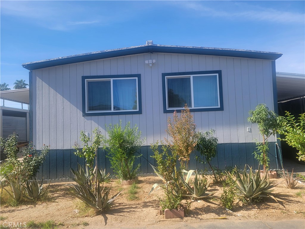 A welcoming 1,152-square-foot mobile home awaits at Space 96 in the Santiago Estates Sunny mead community, offering a harmonious layout with two bedrooms and two bathrooms. Built around 1974, this single-story residence features both central heating and air conditioning, and a refreshed, remodeled kitchen complete with laminate counters and modern appliances including a microwave and electric dryer hookup. The home’s practical entry via Santiago Drive leads into a thoughtfully designed living space that balances comfort with functionality.
Nestled within a friendly, all-ages community, this property includes access to a shared association pool—perfect for recreational cooling on warm afternoons. The surroundings are well maintained, with landscaped grounds and connected public utilities adding to its convenience. Parking is generous, with four garage spaces included.
The community itself, Santiago Estates Sunny mead, offers a relaxed, residential retreat while being centrally placed for easy access. It sits in close proximity to key transportation arteries—the 60 and 215 freeways—as well as March Air Reserve Base, making commutes smooth. Whether you're heading to natural escapes like Big Bear, Lake Arrowhead, or Palms Springs, or family attractions such as Disneyland or Knott’s Berry Farm, everything remains within an hour’s reach. Nearby Lake Perris brings outdoor recreation too, from camping and fishing to the lively Southern California Fair. In everyday life, essentials like shopping, dining, medical care, and schools are also conveniently close.
As for community amenities, residents enjoy a clubhouse, a pool, a playground, basketball courts, on-site laundry facilities, RV storage, and a welcoming pet-friendly environment.
In essence, Space 96 offers a well-appointed and refreshed living space in a calm, yet well-connected community. Its size and layout make it for families seeking both comfort and convenience in Moreno Valley.
