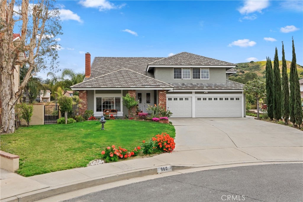 Breathtaking panoramic canyon views await you atop a tranquil cul-de-sac in Anaheim Hills. Nestled on a hillside is this nearly 3400 SF 5 bedroom, 2 and a half bath residence. Interior amenities include crown molding, raised panel doors, beautifully upgraded stone-infused bathrooms, and a neutral paint palette throughout. A welcoming tile porch entry and large grassy lawn invites you inside. Be delighted by the spacious living room with warming fieplace, soaring vaulted ceilings, and the adjacent light-filled dining room. The light and bright island kitchen boasts granite countertops, custom range hood, and opens to the oversized family room with beamed ceilings, sizable wet bar and built-in media center. Retire upstairs to the immense primary suite with dual vanities, spa-like shower and enjoy the sumptuous soaking tub. The additional four large secondary bedrooms complete the second level. Take in the spectacular views from the expansive yard, featuring a sparkling pool and spa, coy fire pit, and granite and stone BBQ center. Complete with a 3-car garage, this home has the incredible location, floor plan, and amenities you have been waiting for.