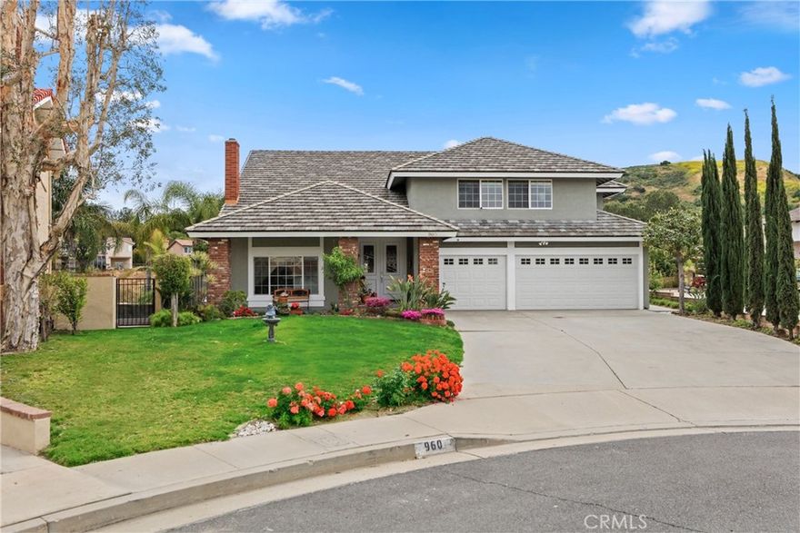 Breathtaking panoramic canyon views await you atop a tranquil cul-de-sac in Anaheim Hills.  Nestled on a hillside is this nearly 3400 SF 5 bedroom, 2 and a half bath residence.  Interior amenities include crown molding, raised panel doors, beautifully upgraded stone-infused bathrooms, and a neutral paint palette throughout.  A welcoming tile porch entry and large grassy lawn invites you inside.  Be delighted by the spacious living room with warming fieplace, soaring vaulted ceilings, and the adjacent light-filled dining room.  The light and bright island kitchen boasts granite countertops, custom range hood, and opens to the oversized family room with beamed ceilings, sizable wet bar and built-in media center.  Retire upstairs to the immense primary suite with dual vanities, spa-like shower and enjoy the sumptuous soaking tub.  The additional four large secondary bedrooms complete the second level.  Take in the spectacular views from the expansive yard, featuring a sparkling pool and spa, coy fire pit, and granite and stone BBQ center.  Complete with a 3-car garage, this home has the incredible location, floor plan, and amenities you have been waiting for.