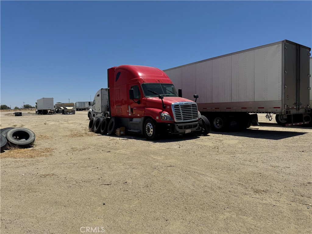 GREAT PARCEL FOR A GREAT BUSINESS!!! This 5 acre+ lot has the capacity to park 109 trucks and produces monthly income. This property has a COMMERCIAL USE OF LAND And offers
a paid off solar system, commercial water meter, fully chain link fenced out except one wall that is blocked and has been shared with the northside neighbor. This parcel is for Sale along with the Business