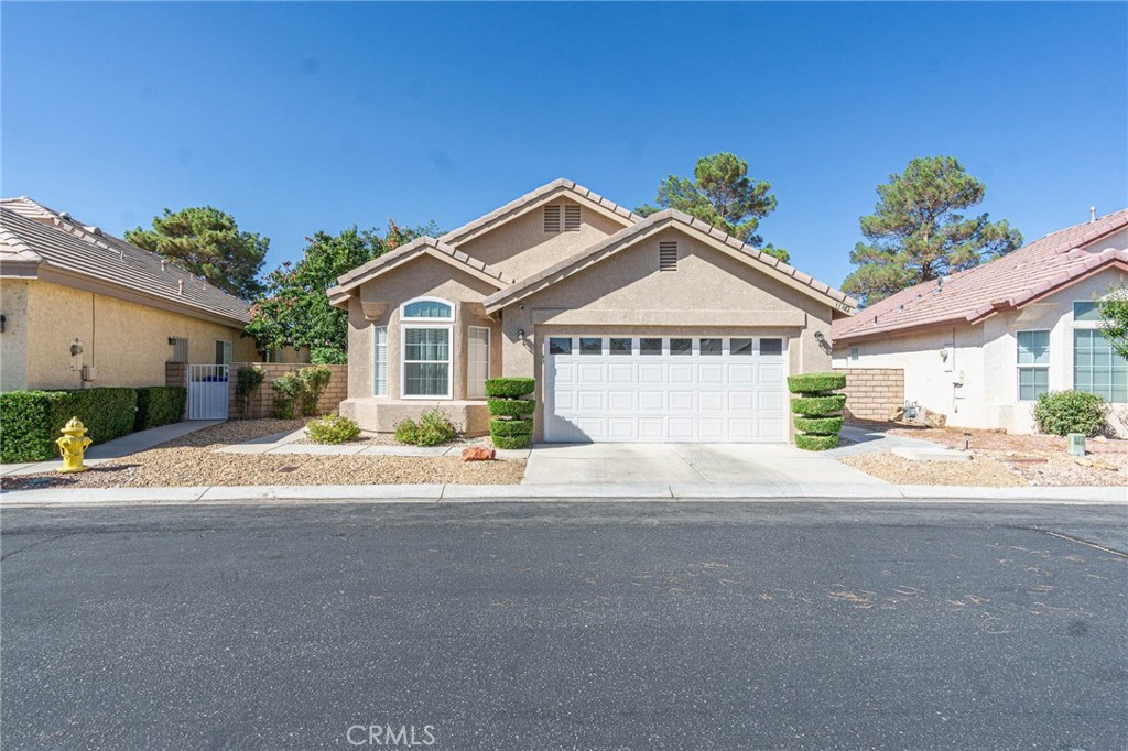 Welcome to your new home in the Wydham Rose 55+ gated community of Apple Valley. When you enter the home you will find a nice fireplace and wet bar waiting for you. The living room and a family room which looks out onto the pond area and golf course for that relaxing feeling. This home features 2 bedrooms 2 baths. Kitchen is good size with nice pantry and has eating area and desk area. There's a door in the kitchen that will lead you out the to the private patio area which you can also enjoy with trees and flowers and grass. Guest bedroom is nice size and has closet. You find indoor laundry area for your convenience. The primary suite is large and has ceiling fan. Step into the primary bath and find nice soaking tub after that long day and also has shower double sinks and walk-in closet and skylight. So go set out by the pond enjoy the sunsets and mountain views and know you have found a place to call home.