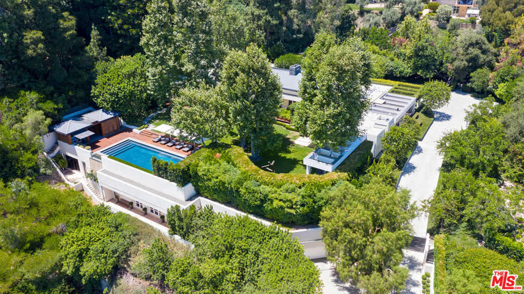 One of Beverly Hills most private and secluded estates, situated on over 3 acres. A sprawling contemporary compound featuring a 9,200 sf (4 bd/6bth) 1 story main house, 2 guest houses, separate gym, gorgeous pool with pool house and underground garage. Impeccably remodeled with the highest level of quality, taste, and craftsmanship. Featuring resort-like grounds, stunning outdoor living, dining and entertainment areas, a reflecting Koi pond, manicured lawns, and zen-like gardens. Beautiful city and ocean views throughout complete this incredible and irreplaceable estate. Shown to pre-qualified clients only.