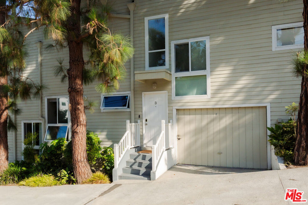 Spacious Townhouse in Ocean Park just 5 blocks from the beach! Nestled in the heart of Silicon Beach, this rare 2-bedroom, 2-bathroom townhome offers the perfect blend of coastal charm and modern comfort. Step inside to an airy open floor plan with soaring beam ceilings, hardwood floors, and a cozy gas fireplace, all bathed in natural light from expansive windows. The beautifully updated kitchen features sleek cabinetry, stainless steel appliances, and a generous island - perfect for morning coffee, casual meals, or hosting friends. A stylish guest bath completes the main level. Upstairs, two spacious bedrooms feature dramatic 12-foot vaulted ceilings, abundant closet space, and a remodeled bath accented with timeless white subway tile. Head up to the private rooftop deck to soak in city and treetop views ideal for dining under the stars, lounging with a book, or enjoying those unforgettable Southern California sunsets. Added conveniences include an in-unit washer/dryer and a two-car semi-private garage. Just blocks from the sand and minutes from the vibrant shops, cafes, and restaurants along Main Street, Abbot Kinney, and Rose Avenue, this home places you at the center of Santa Monica and Venice's most sought-after lifestyle. A rare Ocean Park gem not to be missed!