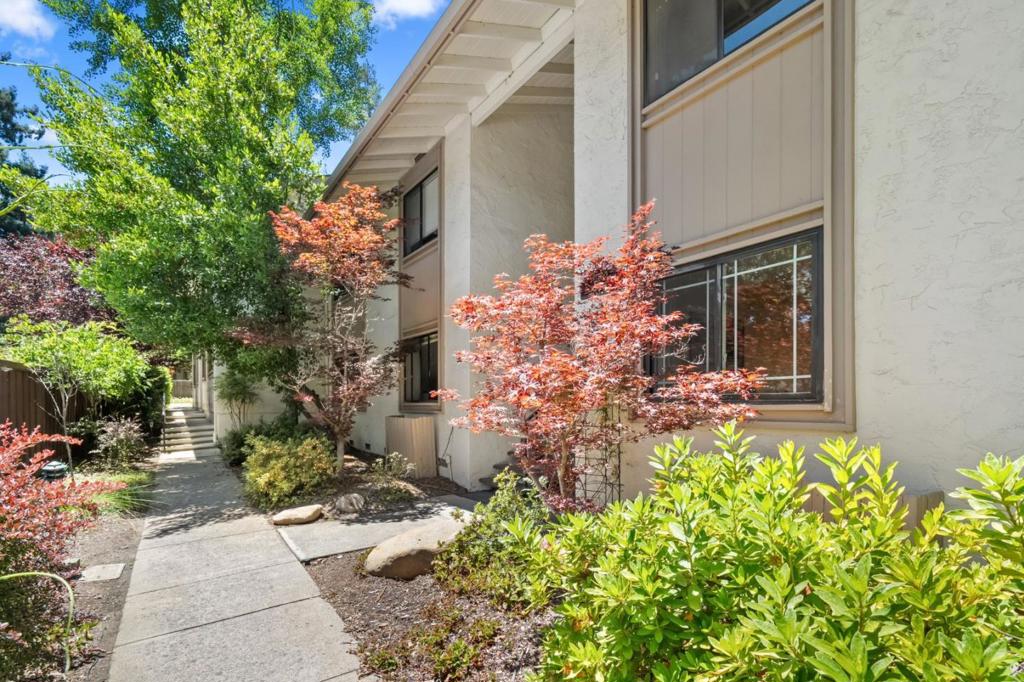 This quiet, first-floor unit is peacefully nestled in a prime Saratoga location with a park-like setting. Enjoy walking distance to top-rated Saratoga schools, fine dining, charming shops, Wildwood Park, Hakone Gardens, and scenic hiking and biking trails. The home features an open layout with a spacious living and dining area centered around a cozy fireplace. Interior highlights include solid cherry wood cabinets, double-pane windows, and an in-unit washer and dryer. The residence opens to a peaceful open area, blending indoor comfort with natural surroundings. Community features include a heated pool, jacuzzi, clubhouse, and recreation room, offering both comfort and convenience in one of Saratoga's most desirable neighborhoods.