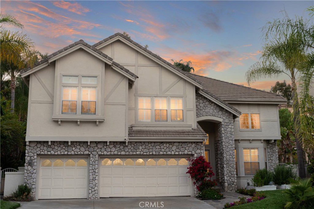 Luxury Live Auction! Bidding to Start from $2,200,000! Welcome to 27153 Woodbluff, a stunningly updated 5-bedroom, 4.5-bathroom home nestled in the highly sought-after Moulton Ranch community of Laguna Hills. This spacious and meticulously maintained residence offers over 3,800 square feet of refined living space, blending timeless elegance with thoughtful modern upgrades. As you enter, you're greeted by soaring ceilings, expansive windows, and an open-concept floor plan that invites abundant natural light throughout. The main level features rich hardwood flooring and multiple living and entertaining areas, including a formal dining room, living room with fireplace, and a generous family room that flows seamlessly into the heart of the home—an exquisitely remodeled gourmet kitchen. Designed with both style and functionality in mind, the kitchen showcases custom cabinetry, granite countertops, stainless steel appliances, a reconfigured sink and counter space, and a large center island—perfect for casual dining and entertaining. The adjacent family room offers a warm and inviting atmosphere with a beautifully appointed fireplace and easy access to the backyard. A main-level bedroom with a private en-suite bath offers flexible living options for guests, extended family, or a dedicated home office. Upstairs, brand-new plush carpeting adds comfort, while the expansive primary suite serves as a true sanctuary. Enjoy a fully rebuilt spa-like bathroom with designer finishes, dual vanities, soaking tub, a large walk-in shower, and a custom walk-in closet. A second fireplace, also newly redone, adds a touch of luxury to the suite. Additional highlights include a fully renovated powder room, an upstairs laundry room for convenience, and three additional secondary bedrooms—each generously sized and filled with natural light. Step outside to a private backyard surrounded by mature landscaping, offering the perfect setting for outdoor dining, entertaining, or peaceful relaxation. Completing this exceptional home is a spacious 3-car garage, low HOA, and proximity to top-rated schools, parks, hiking trails, and major shopping and dining destinations. With quality upgrades throughout and located in one of Laguna Hills’ most desirable communities, this home is a rare opportunity you won’t want to miss.
