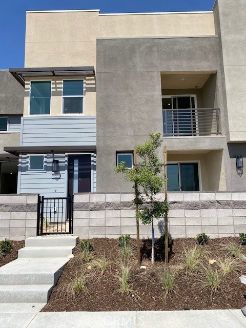 Eave, a vibrant collection of CA Modern courtyard townhomes designed for comfortable living in the open airy layout. This 2 bedroom, 2.5 bath and 2 car garage offers a modern design and stylish comfort. Discover a move-in ready home where style meets comfort. This vibrant residence boasts a flowing layout, complete with a spacious living area and an inviting outdoor patio, perfect for entertaining and soaking up fresh air and sunshine. This is designed for those seeking both elegance and functionality, featuring a Samsung 30 slide-in induction range with a self-cleaning oven, an over-the-range microwave, and a dishwasher-all in sleek stainless steel. The kitchen shines with white flat-panel cabinets and Quartz counters. Bathrooms are elevated with Bella Carrara marble countertops. Your ideal home awaits! Endless Amenities: resort-style lap pool and kiddie pool, jacuzzi, half basketball court, passive park, dog park, children's playground, fire pit, BBQ and corn hole. Home ready for move in July 2025. California Modern exterior.