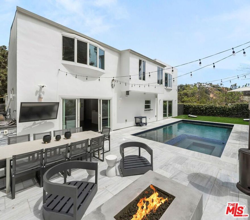 Welcome to this beautifully updated 4-bedroom, 3-bathroom contemporary residence, ideally situated in the heart of Pacific Palisades. This home combines refined modern design with a relaxed California comfort with an exceptional indoor-outdoor living experience. The property features a spacious open-concept floor plan with a casual sitting room and an expansive living room perfect for both entertaining and everyday living. The modern kitchen is appointed with high-end Wolf and Subzero appliances, clean lines, and seamless flow to the adjacent dining and living areas. Upstairs, you will enjoy partial ocean and vineyard views. The home has been fully remediated and meticulously maintained after surviving the recent wildfire, offering peace of mind alongside contemporary style. The primary suite includes custom California Closets, adding both elegance and functionality. A fully renovated garage, also outfitted with a California Closets storage systems, provides an organized and versatile space to meet a variety of needs. With four well-proportioned bedrooms and three modern baths, all with Toto toilets, this home offers flexibility and comfort for families or those seeking space to live and work. Gorgeous outdoor space with built in seating, a fire pit and a large saltwater pool sits alongside a fitted outdoor kitchen with a BBQ and Ooni Pizza oven. Do not miss this rare opportunity to own a turn-key home that balances modern amenities, resilience, and the best of Palisades living.
