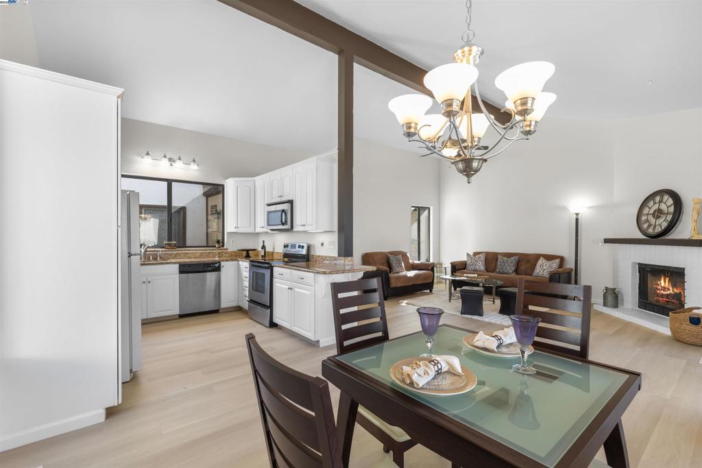 Welcome to Sunny Glen, a fabulous 55+ community in San Ramon. This residence lives like a townhome with no neighbors above or below. The open floor plan features soaring vaulted ceilings and abundant natural light that fills the living spaces. The kitchen has been tastefully updated with slab granite counters, while all of the areas, along with the bathrooms, showcase new flooring and paint throughout. Enjoy year-round comfort with a newer heating and A/C system. The primary suite offers a walk-in closet, and the in-unit washer and dryer add everyday ease. Relax outdoors on one of two private decks, or take advantage of the community amenities, including a sparkling pool and clubhouse. A one-car detached garage is included, and the excellent location puts you close to shopping, dining, the senior center, easy freeway access (580/680), and the Iron Horse Trail.