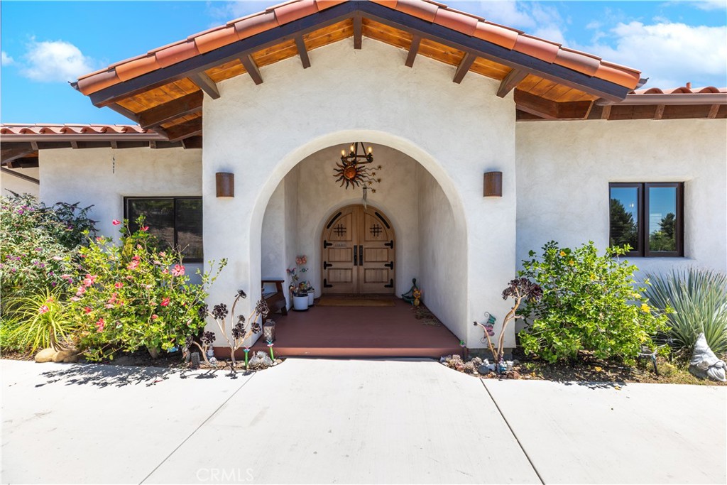 Come relax and enjoy the views, serenity and spirit of this single story ranch home. Designed by Hubbell and Hubbell this Spanish style “Straw Bale" home was built in 2019 with natural non-toxic and environmentally friendly materials. The exterior walls are 25 inches thick to provide maximum insulation. When you walk thru the charming double wood front doors you truly feel you are entering a different world. The artistry and warmth is evident throughout. From the family friendly kitchen with beautiful cabinetry to the views from every window you can't help but feel like you are in a very special space. The 4 bedrooms are spacious and offer unique features all their own. The vanities in all the bathrooms are beautifully artistic and hand epoxied by the owner. The wood doors throughout the home are beautiful adding more depth to this already beautiful home. As you step out to the over 1000 sq.ft. wrap around patio take in the breathtaking view atop these 4.21 acres. Waiting below is a graded pad awaiting your vision. Please enjoy viewing this home and take in all that is has to offer.