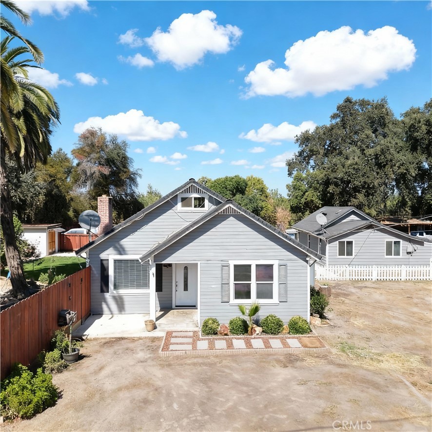 Private country-themed property on a spacious 0.66-acre lot featuring two residences and multiple upgrades. The main home offers 1,887 sq ft with 3 bedrooms, and 1 bath. The secondary home includes 792 sq ft with 2 bedroom, walk-in closet, and 1 bath, with a separate PG&E meter. Additional amenities include a workshop, shed, storage, BBQ podium, cement sidewalks, white fencing, and power for a camping trailer. Recent updates include a newer AC unit, backyard lawn, fencing, and small fish pond. Perfect for multi-generational living, rental income, or a private retreat.