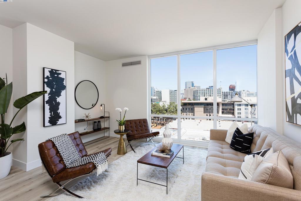 Sleek, modern, fully remodeled one-bedroom, one-bath, boasts a dynamic cityscape view and a perfect entertainment kitchen. Rich black cabinets and stunning quartz counters take center stage to the open living design. Floor to ceiling windows showcase the city lights. Designer lighting and hardware add a nice polish to a classic style. The beautiful light floors have a farmhouse rustic grain. They provide a lovely contrast to the smooth walls and dark cabinets. The bedroom offers double closets, dynamics views, and a terrific balcony. The bathroom is spacious and nicely appointed with a large soaking tub and a separate stall shower. Parking and storage are also included. The Ellington is minutes from BART, the Alameda/Oakland Ferry, and Amtrak. Walk to a plethora of fine restaurants, bars, breweries, theater, music, and art galleries. This modern full-service high-rise has 24/7 concierge, beautiful pool deck with heated pool, spa, showers, and BBQ. It also has an impressive fitness center, and a terrific community lounge, with full kitchen, tables, soft seating, and DirecTV™. This is luxury urban living at its finest.