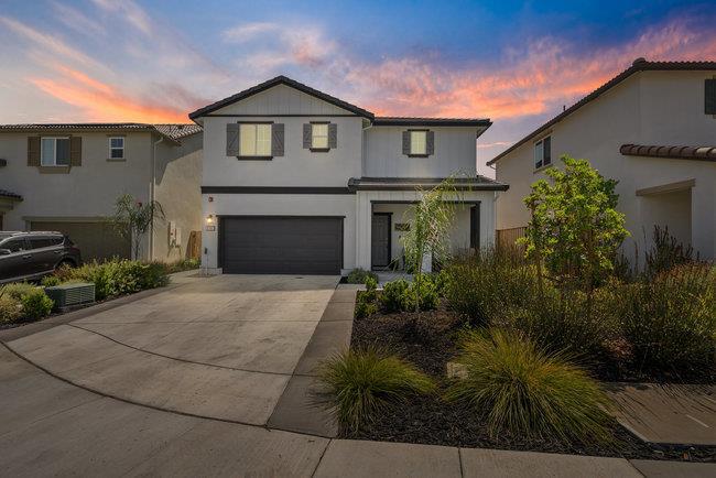 Welcome to SUMMERSTONE and this LIKE NEW home located in the vibrant & growing City of Gilroy! This spacious residence boasts 1,762 sq ft with 4 bedrooms and 2 full bathrooms, including a convenient 1/2 bath on the ground floor. The HEART of the home is the GORGEOUS kitchen, featuring an electric cooktop, quartz countertops, white Shaker style cabinets, stainless steel Whirlpool appliances and a kitchen Island with seating - perfect for culinary enthusiasts! The kitchen flows seamlessly into the family room, creating an ideal space for gatherings. Mohawk carpet and Luxury Vinyl Plank flooring for easy living! Enjoy the comfort of multi-zone central AC and heating, with the added benefit of OWNED SOLAR! Installed EV charging plug in the garage, Honeywell touchscreen programmable thermostats, LED lighting, Smart Home Features and Deako light switches are just a few of the builder upgrades included! All bedrooms, a loft space & the laundry room are located upstairs for ultimate privacy. The extra wide driveway, newly installed backyard landscaping w/ a concrete patio, cul-de-sac location & the exclusive gated park make this home an A+ choice! Rural space behind with no 2-story neighbor looking over you. Easy commute access & close to dining/shopping/parks/sport areas/entertainment.