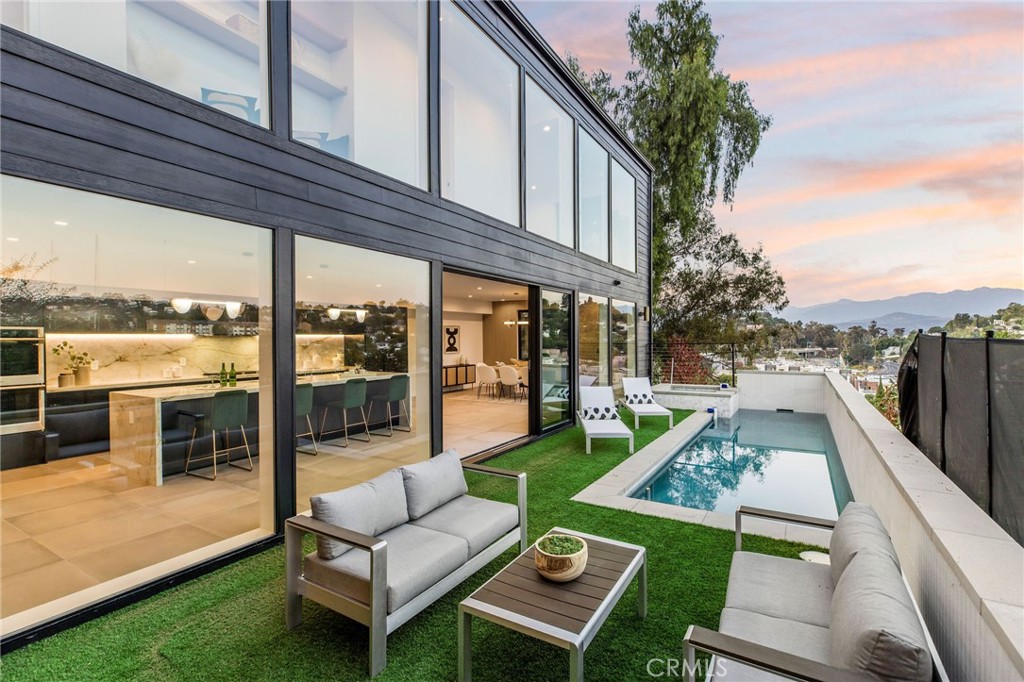 Perched at the pinnacle of iconic Silver Lake positioned impeccably for unparalleled privacy while simultaneously offering sensational views. Stylish and spacious urban contemporary living meets peaceful tranquility. Upon entry, indulge in a sophisticated open concept design featuring a plethora of designer finishes with abundant natural light as the property features bold and expansive floor to ceiling windows maximizing the architectural significance and a lifestyle of seamless indoor/outdoor living. The kitchen features a truly extraordinary 12-foot himalayan crystal porcelain island and backsplash, expansive walk-in pantry, wine fridge and double ovens to inspire even the most discerning culinary enthusiast. The upper-level features 4 spacious bedrooms and 4 en-suite bathrooms all thoughtfully positioned for privacy. All bedrooms feature separate closets for ample storage. The primary suite is a exquisite retreat, featuring a beautiful calacatta monet marble fireplace, a sizeable walk-in walnut wood closet, along with a balcony overlooking the pool, majestic city and mountain views as well as a spa inspired bathroom. The upper level is also equipped with a laundry room. The property is equipped for home audio and has security cameras in place. The location is within close proximity to all the best boutique shopping, stylish coffee shops and exceptional dining in the area.