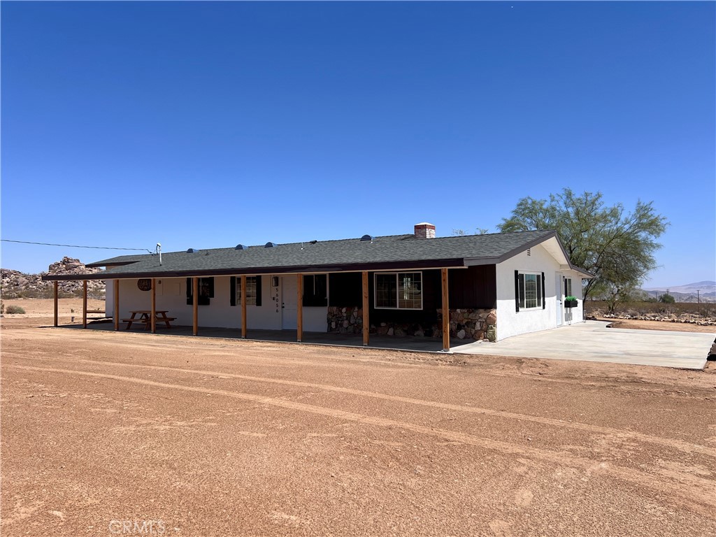 2 HOMES ON 5 ACRES OF FLAT LAND, FULLY REMODELED! Don't miss out on this unique opportunity to own TWO separate homes with separate entrances. The drive there is paved right off of Old Woman Springs Rd Highway and Linn. There is no other property being sold in the area like this one. Both homes have been updated completely. House address 56056 boasts an estimated 2,326 sqft and features a new roof, new air conditioning and heating system, new plumbing, new upgraded electrical panel, kitchen fully updated, new vinyl flooring, new updated bathrooms, new covered patio to name a few upgrades. It also has an attached workshop that is waiting for your touch. House address 2128 has an estimated 1,345 sqft and features a new roof, new air conditioning and heating system, kitchen fully updated, new plumbing, new recess lighting, new glass sliding door, updated bathrooms and much much more! There is also an ample sized shed in the lot, perfect for storage. It is located 10 mins away from shopping centers, restaurants and entertainment and King of the Hammers. It's about 20 mins away from Joshua Tree National Park & Pioneertown and 5 minutes to the History Channel featured Integratron. This is perfect for two families wanting to live together but separate at the same time or live in one and rent the other. The 5 Acres of land provide numerous possibilities including building other units. It can also be used as a short term rental (Airbnb) or long term. This property fits any type of buyer you may have from First Time Home Buyers to Investors. Act fast, this property won't last long! Storage containers will be removed from the property at closing. Motivated Seller