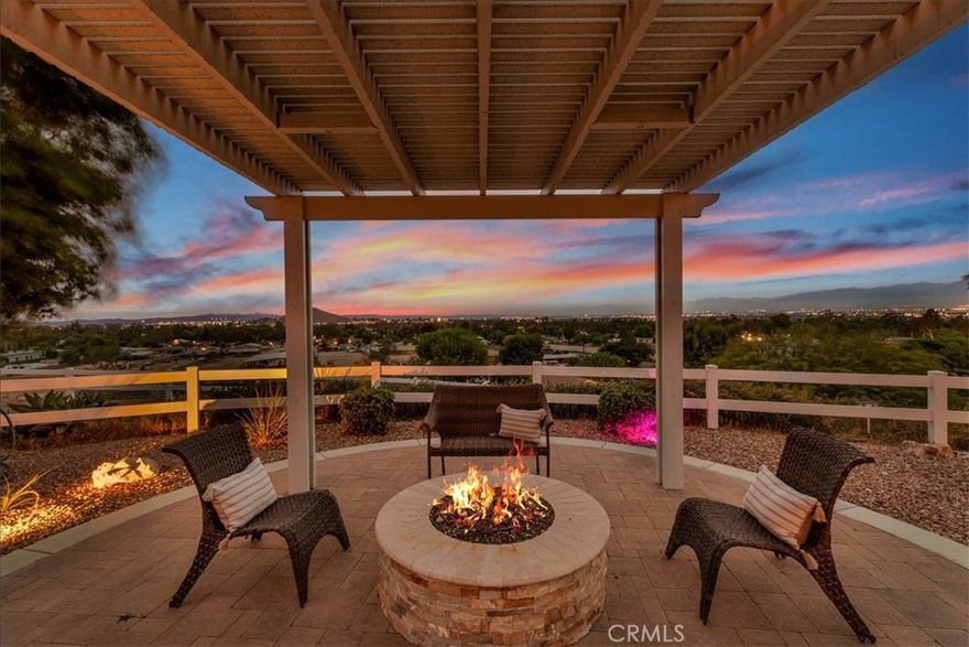 SPECTACULAR VIEW HOME & HORSE PROPERTY on 1.72 Acres! Do you want a PANORAMIC VIEW with morning SUNRISES and nightly SUNSETS?  This one has it. This gorgeous home overlooks the entire Norco Valley.  The back of the property has views of the Pumpkin Rock hiking trail and Ingalls Equestrian Center where we hold rodeos, fairs and all sorts of fun community events. Sit back in the front yard and enjoy your morning coffee or evening drink, relaxing and enjoying the views and the firepit watching DAILY SUNRISES and NIGHTLY SUNSETS. 32 PAID-OFF solar panels to help keep your electricity bill low.  This home has curb-appeal and charm as soon as you drive up, you will gaze at the view and enjoy the nice breeze on top of this hilltop home. This home has wonderful features such as the formal dining room (or use as a living room) where you can serve your guests and enjoy gazing from the large window with the sunrise and sunset views.  The kitchen has been remodeled and replaced with stainless steel appliances, newer cabinets and a kitchen island overlooking your family room.  The stove/oven is a convection oven and self cleaning oven. The living room has high ceilings and the entire house has recessed lighting through-out.  The primary bedroom has a large sitting area or could also be used as an office or nursery.  The oversized walk in closet has built-in shelving you will fall in love with.  The primary bathroom has a jetted soaking tub, perfect to relax after a long days work.  Huge walk in shower and separate double vanities. The seller has replaced all plumbing with copper plumbing.  The main house features  2,236 sqft of living space with a 260 sqft enclosed patio.  The garage/storage area is approximately 704 sqft and would be a perfect space to add a Junior Suite/ADU. The exterior has a cute river rock water fall to listen to & relax by.  There are 6 chicken coops ready for you to raise your own chicken farm.  There are multiple areas where you can have all your other animals such as horse, goats, cows and anything you wished you could own.   There are multiple sheds for feed storage and personal storage that are included. Raised flowerbeds perfect for you to grow all your own fruits and vegetables.  There is a drip system to the plants and planters. You will own this beautiful home and the whole hill and be secluded from neighbors with peace.  The long drive way up adds for a lot of privacy.  This is a one of a kind property you must have!