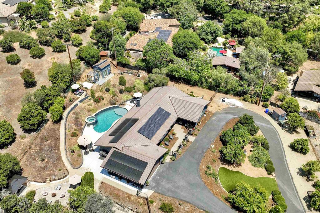 Set off of Via Rancho on a quiet private road. A stunning freshly renovated single level estate set in desirable southwest Escondido, thoughtfully updated with panoramic views. This gorgeous home is well appointed starting with the interior open floorplan adorned in tasteful high quality engineered wood flooring, new custom light led fixtures and pendant lighting, a new gourmet kitchen fit for an executive chef, desirable Thermador appliances including a built in refrigerator, dual ovens, induction cooktop, custom finished hood/vent, microwave drawer, and custom cabinetry with soft close and dovetail drawers. Featuring 4 bedrooms, the primary suite hosts a new glamorous bathroom with new dual vanity, sitting make up quartz counter, with custom shower enclosure. The secondary bedrooms feature generous room sizes, a secondary bathroom features custom tile flooring, new counters, sinks and light fixtures. A very convenient half bath with custom closet organizers serves the interior guest and outdoor entertaining space. The backyard space with a newly constructed pool and spa, with new decking, a pool house/ADU/casita provide additional changing and retreat space. Fruit and Citrus trees throughout, a freshly paved circular driveway with room for RV parking and guest parking, a newly installed septic system, upgraded electrical panel and solar system. Set on a .69 acre lot, there is no HOA or Mello Roos. A family compound. Home Upgrades 1. All Newer Electric 2. Newer Roof 3. Upgraded insulation in the attic for prevention of rodents 4. Newer traffic rated commercial grade septic system 5. Newer custom-built kitchen and bathroom cabinets 6. Upgraded appliances (Thermador) 7. Custom hood vent 8. All newer walls 9. Paint on interior and exterior 10. Removed family room wall 11. All newer flooring 12. All newer lighting 13. Ceiling fans throughout 14. Custom California closets in all rooms and hallway closet 15. Recently had dryer vents and chimney inspected (Annual inspection) 16. Pool and Spa 17. Concrete in backyard 18. Garage drywall 19. Landscaping 20. Unpermitted ADU 21. All newer asphalt, circular driveways and down the shared street. 22. Custom countertops 23. Upgraded electrical panel (Approved by SDG&E) 24. Raised living room floors 25. Newer bathroom showers, toilets 26. Newer Sliders, French doors, doors, knobs and installation 27. Front door 28. New Solar System 29. Alarm System with Front Yard Camera 30. Replacement of 3 windows and an additional window in master bath 31. Christmas light outlets at roofline Room for RV, Boat, 5th wheel. Family Compound
