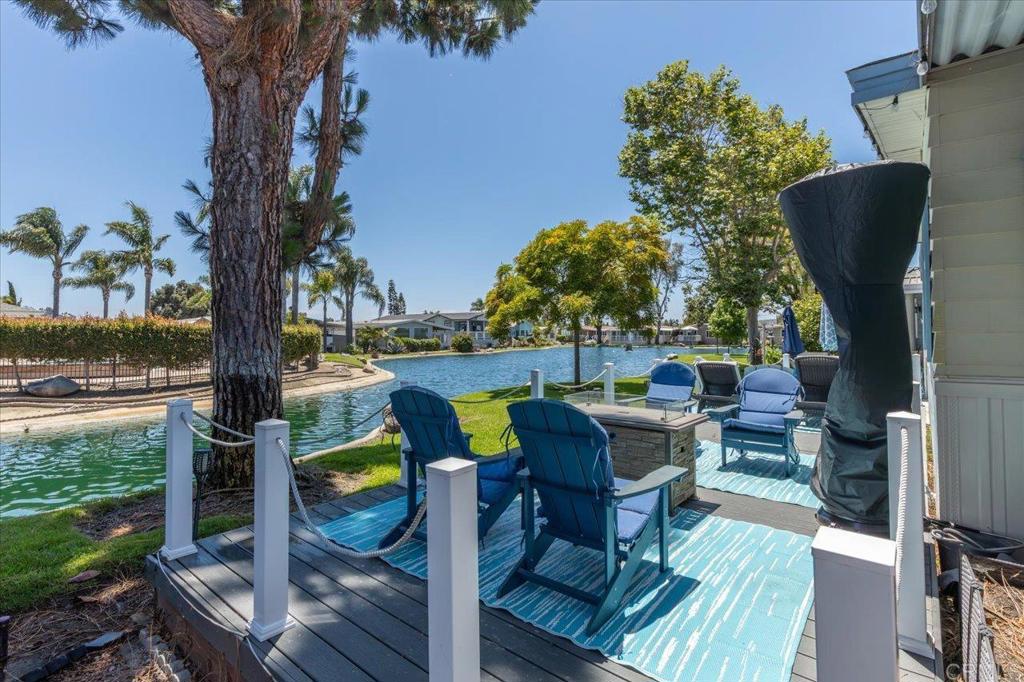 Beautifully Remodeled lakefront home in gated 55+ coastal community w/ rent control & NO property taxes! Step into this stunning, move-in-ready home that radiates pride of ownership, surrounded by lush greenery, scenic ponds, and visiting ducks, this home offers a serene lifestyle with resort-like charm. Enjoy multiple lagoon fountain views and breathtaking sunsets from several rooms inside the home, as well as from the expansive private Trex deck or the covered Trex porch — perfect for relaxing or entertaining. This is not a flip! It has been thoughtfully and extensively remodeled by a general contractor, with custom design touches made by the homeowner for what was meant to be her forever home. Now, due to a change in plans, this meticulously updated home is available for its next fortunate owner. The following upgrades took place between March – July 2023: * New roof. *New luxury vinyl plank flooring throughout. *ALL new dual pane low-e windows throughout and new sliding glass door. *All new doors and hardware throughout - both exterior and interior doors. *Custom built barn door to Primary Bathroom. *New drywall and interior paint. *New exterior paint. *New retractable screen doors on exterior doors. *Releveled foundation and replacement of 33% of the existing piers at that time - any pier the company had a concern about was replaced. *New skirting on exterior. *New water heater. *New top-down-bottom-up custom blinds and Roman shades window coverings. *New recessed LED lighting throughout. *New spacious exhibition style professional Kitchen with custom drop pendant lighting over island and all new LG Smart ThinQ Stainless Appliances, 5-burner self cleaning range with convection oven and air fryer, large over-the-range Microwave and vent, built-in counter depth French 3-drawer refrigerator/freezer with in-door water and ice dispenser featuring ice cubes or crushed ice. Custom cream colored wood shaker style cabinets featuring pull out shelves and soft close drawers, custom drawer pulls and handles; quartz countertops. Large stainless steel double sinks with custom faucet and garbage disposal. The Kitchen also boats TWO pantries with pull out shelves. *All new custom closets in bedrooms built by Closet World. *All new bathrooms: new toilets, sinks, faucets, showers, tile, custom glass enclosure and rain shower head in master bath, deep soaking princess tub in master bath; all new custom cream colored shaker wood cabinets with custom drawer handles and pulls, soft touch drawer closure and quartz countertops; new nautical style lights, new custom mirrors, new medicine cabinets, new flooring. - everything 100% new. *All new custom cream shaker wood cabinets with custom drawer handles and pulls in Laundry room, quartz countertop, LG Smart ThinQ large capacity washer and gas dryer w/ stainless steel interior. This home boasts approx. 1792 Sq Ft. and includes a formal Living room with vaulted beamed ceilings, plus a cozier Family room / Den. The Primary Bedroom offers a retreat, which can be used as a reading nook, office, or hobby area. Coastal/Beach/Nautical theme throughout home, designed with neutral creams, tans and blues. The exterior offers an oversized storage shed w/ electricity; a widened carport that accommodates up to 3 vehicles; custom Trex upper deck patio that is covered and very large custom Trex lower patio deck that is open air in addition to concrete walk-way and small patio. No maintenance Vinyl fencing/rails around decks. Don’t miss this rare opportunity to own a thoughtfully upgraded, turn-key home in one of the area’s most beautiful and well-kept 55+ communities. Laguna Vista is a luxury, gated, 55+ rent controlled community w/ multiple beautiful ponds, fountains, immaculately landscaped grounds, and located only 4 miles from the beach! Park amenities include pool (heated year around), whirlpool spa, pickleball, tennis courts, ping pong, billiards, poker room w/ card tables, dar