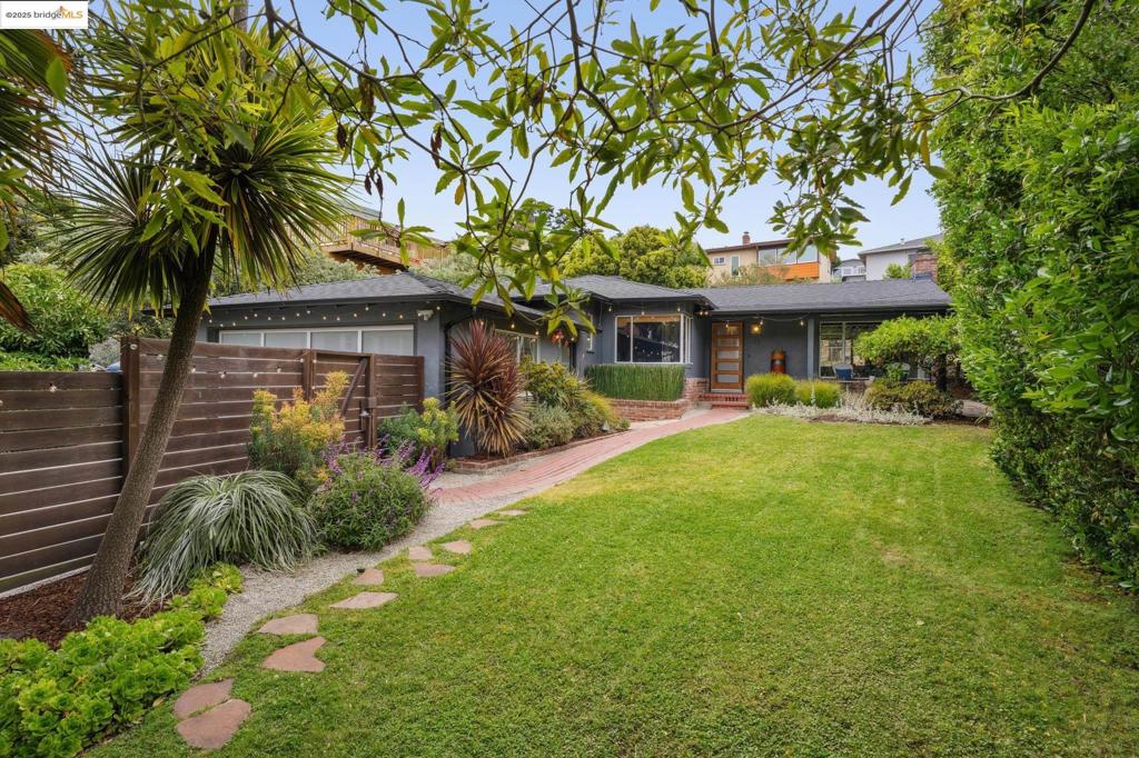 Perfectly situated on a level lot—a coveted rarity in Kensington—this home is a harmonious blend of mid-century charm & thoughtful updates. Front yard is framed by a beautiful, Ipe wood fence w/ a grassy lawn & mature plantings. Inside the living and dining rooms feature distinctive wood-beamed ceilings, a wood-burning fireplace, & huge picture window showcasing a fruiting Meyer lemon tree. Glass doors from both dining room and kitchen lead level out to a spacious deck bordered by lush greenery, w/ built-in bench seating perfect for entertaining or relaxing. Updated kitchen w/ newer cabinets, counters, appliances, & flooring. Laundry room w/ folding counter w/ surrounding cabinetry, plus a pantry w/ pull-out shelves. Bathrooms are serene w/ earth-toned tile & modern fixtures. A standout feature is the fully finished garage, w/ new LVT flooring, skylight, LED lighting, & a mini-split system (heat & A/C) offering comfort in the perfect flex space. Smart updates: Nest system, newer furnace, encapsulated crawlspace, on-demand water heater, & a newer roof. Ideally located near Blake Garden w/ scenic walks offering Golden Gate views, Kensington Village, library & park w/ play structure & sports courts, plus top-rated Kensington Hilltop Elementary. OPEN HOUSES, 6/28 & 6/29, 2:00-4:00pm
