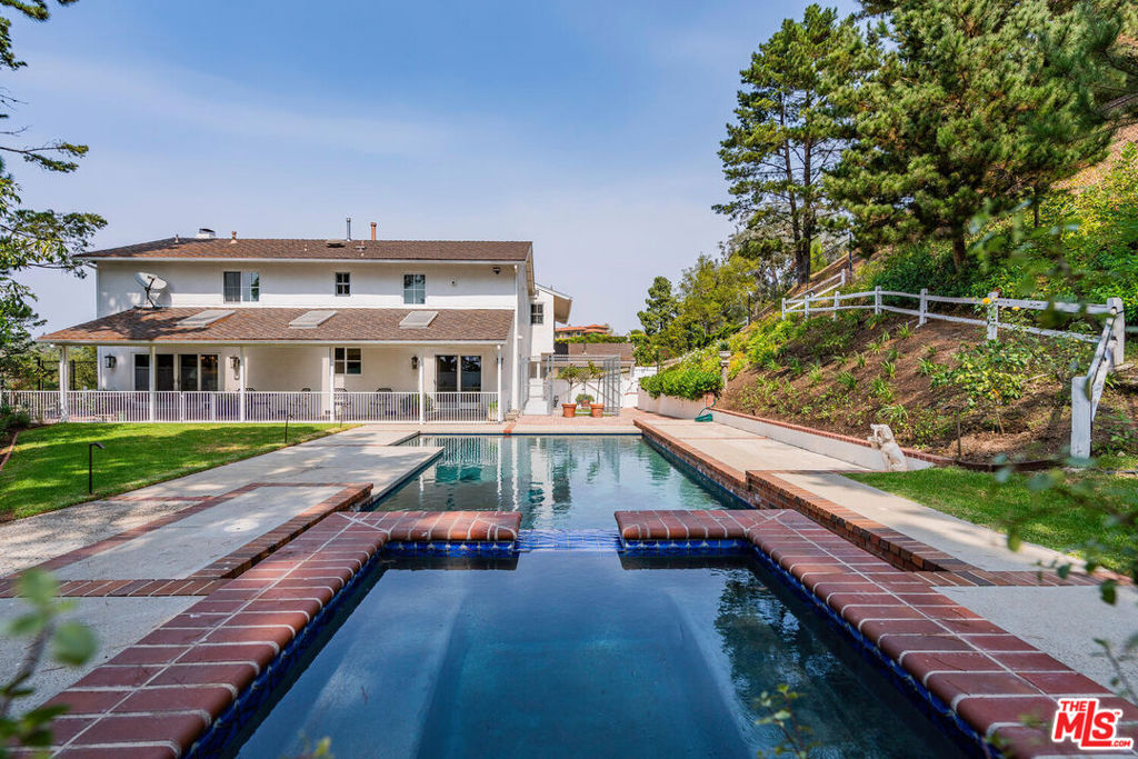 Come experience this private 5 bedroom, 4 bathroom, 3,348 sq ft estate perched atop a canyon on a quiet cul de sac shared with only three homes. Set on one of the larger lots in the area at approximately 1.7 acres, this residence offers Bel Air living at its finest with sweeping views and exceptional privacy. Upon entry, you are welcomed by a light filled living room, perfect for entertaining. Just off the living room, the beautiful chef's kitchen features abundant storage and is ideal for preparing home cooked meals while enjoying views of the expansive swimming pool and grassy yard. The first floor also offers a second utility room with additional storage, an extra refrigerator, and a washer and dryer. An elevator leads to the second level, which includes four bedrooms, among them a grand primary suite. The primary offers spacious his and hers closets, a private balcony, and a luxurious bath with both a tub and shower. With vast views, immense privacy, and a premier location, this Bel Air estate is a rare opportunity. Schedule your tour today.